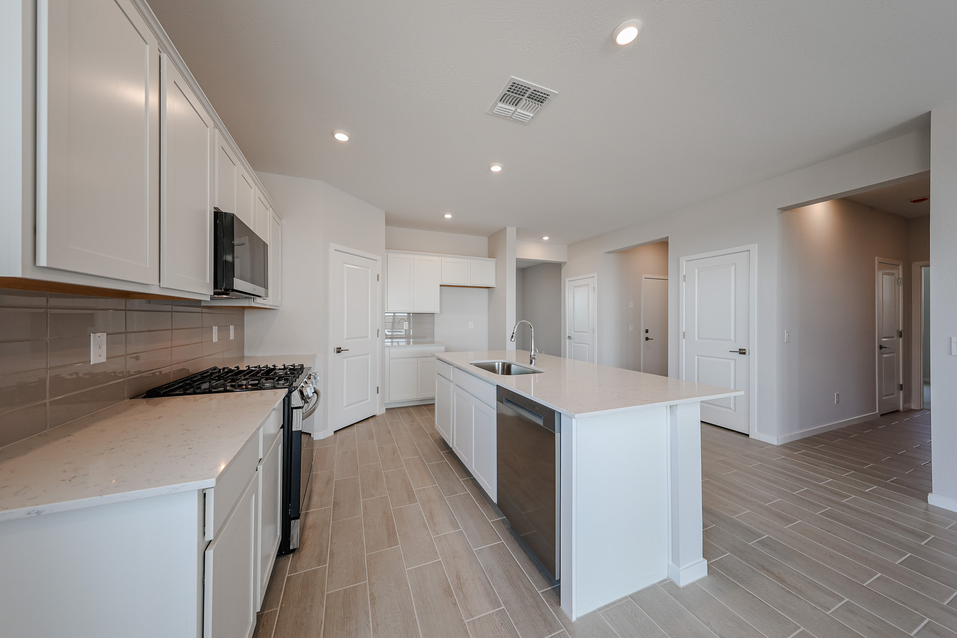 A kitchen with white cabinets.