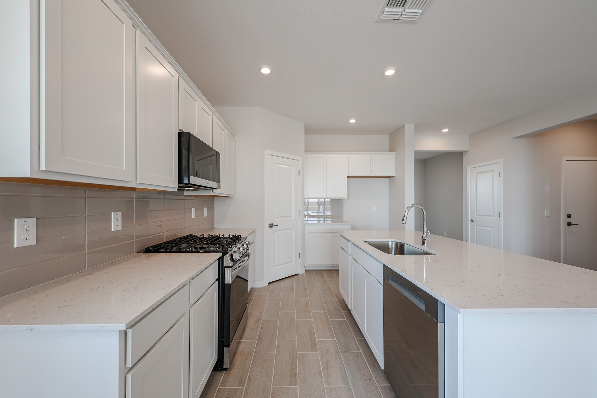 A kitchen with white cabinets.