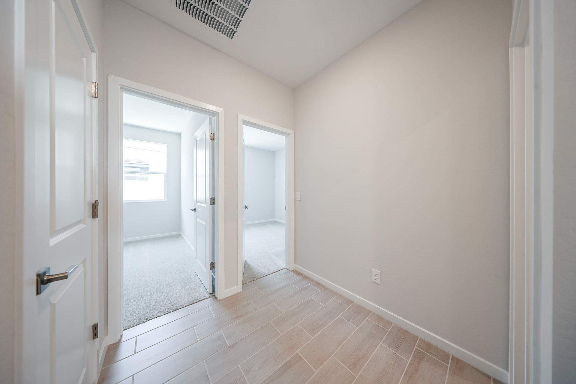 A hallway with white doors.