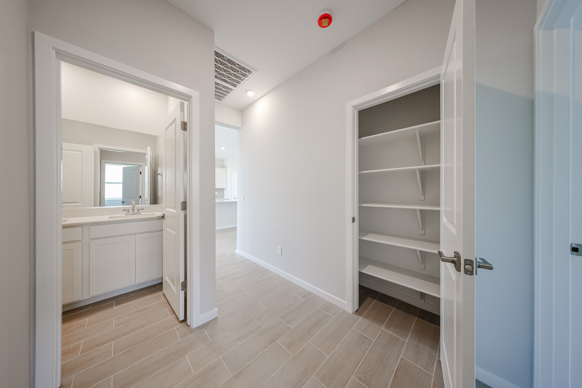 A bathroom with white walls.