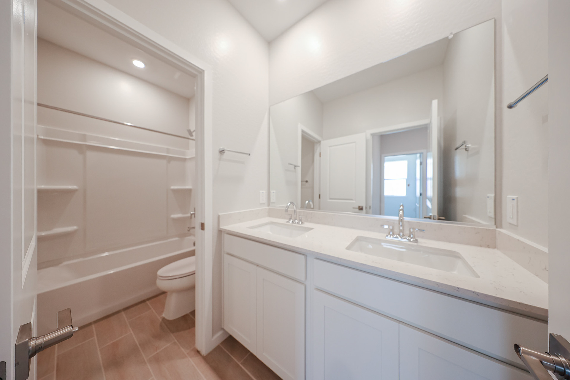 A bathroom with a tub sink and toilet.