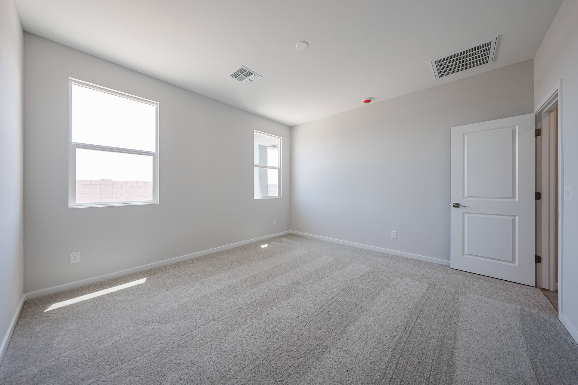 A room with white walls and a carpeted floor.