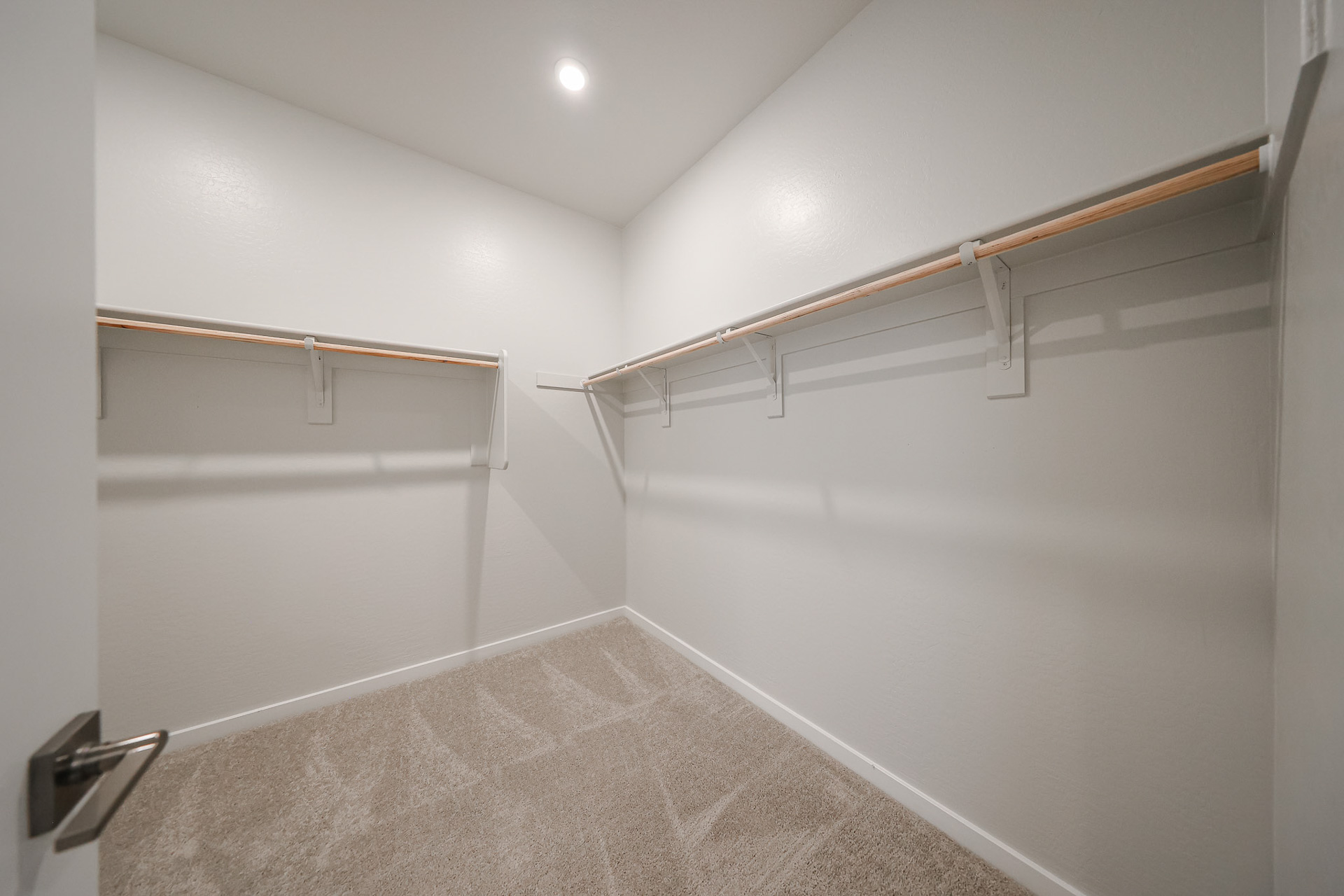 A white room with a metal railing.