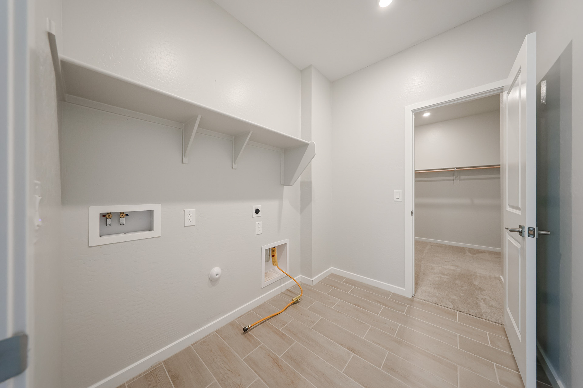 A room with a wood floor and a glass door.