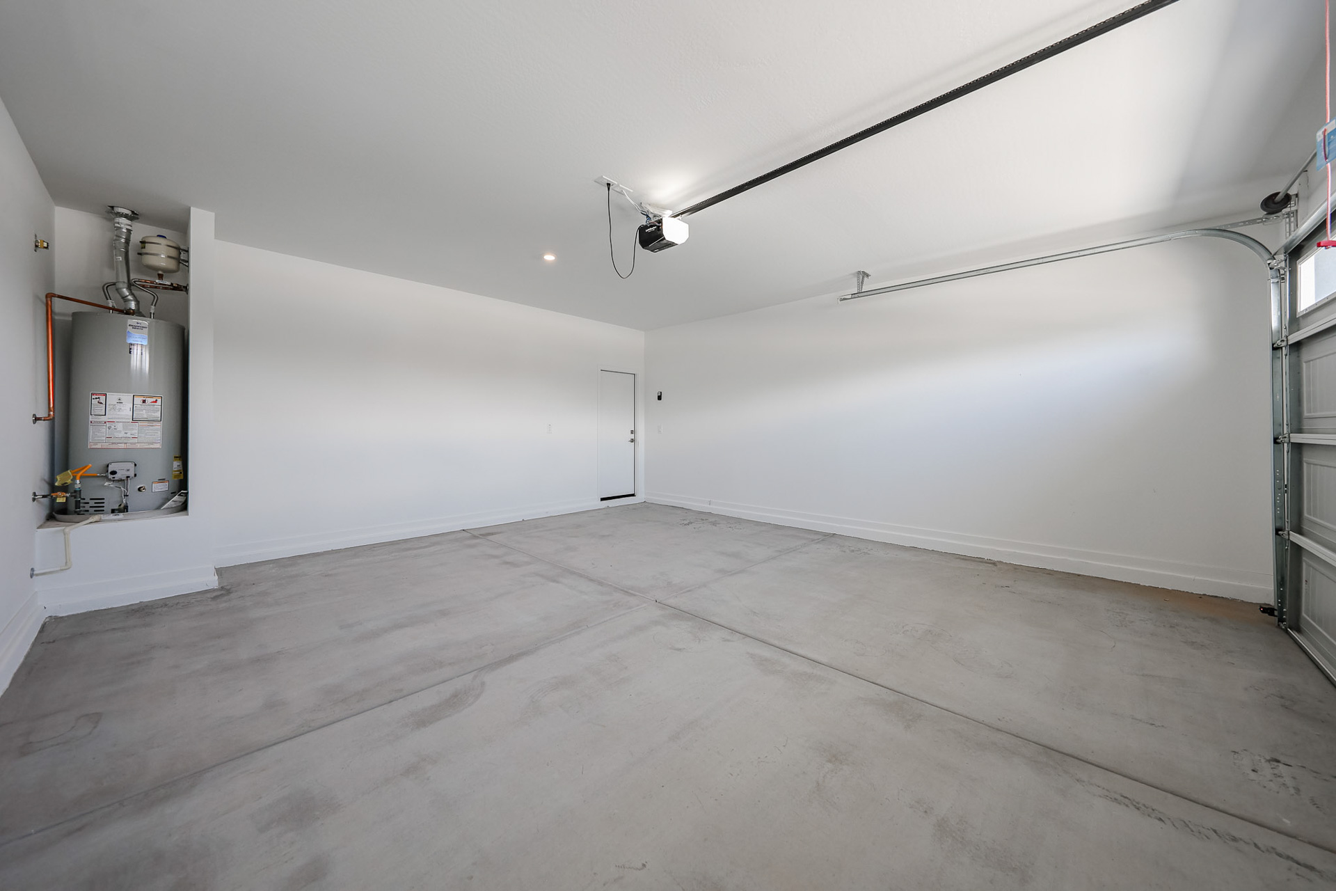 A room with a wood floor and white walls.