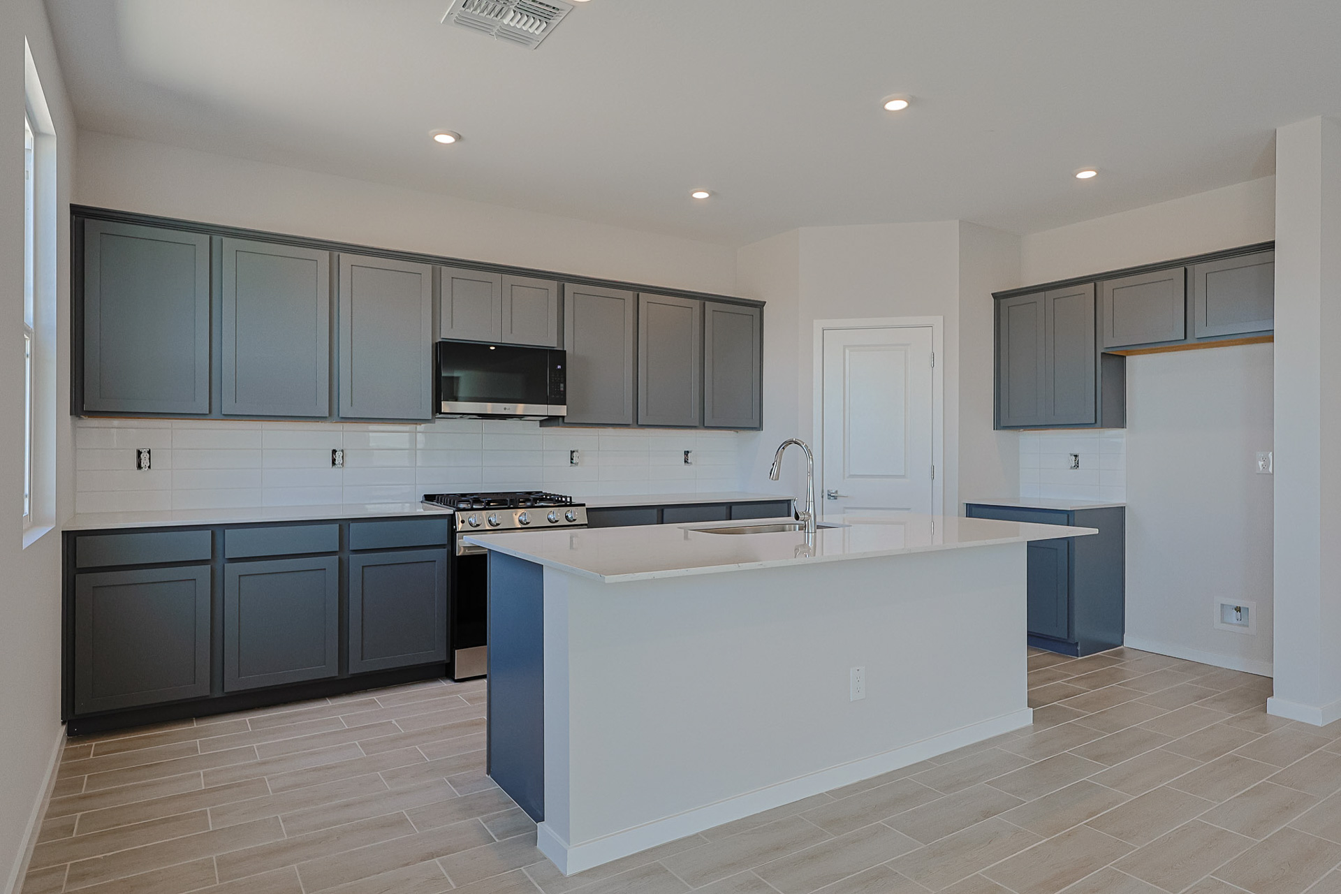 A kitchen with black cabinets.