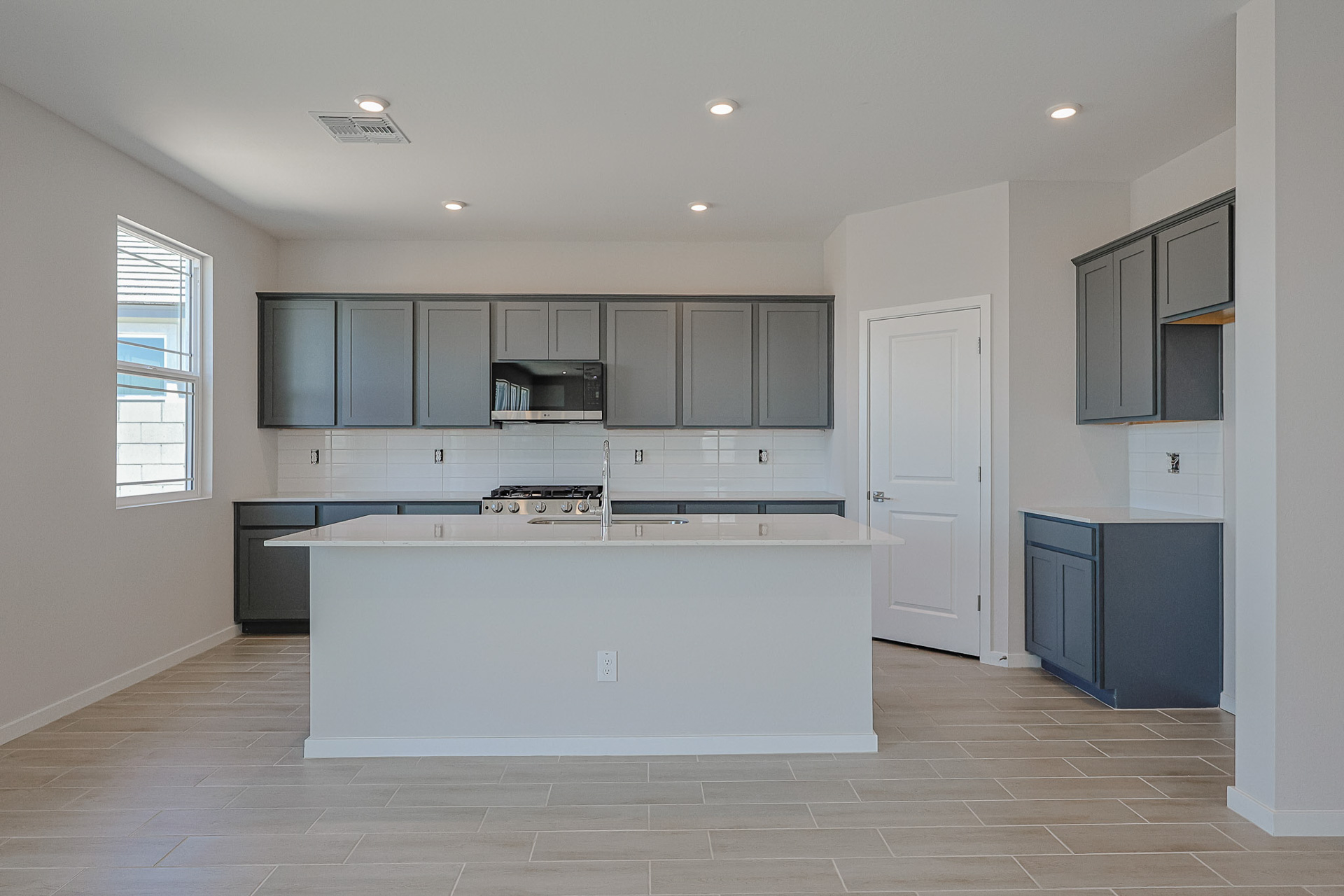 A kitchen with white cabinets.