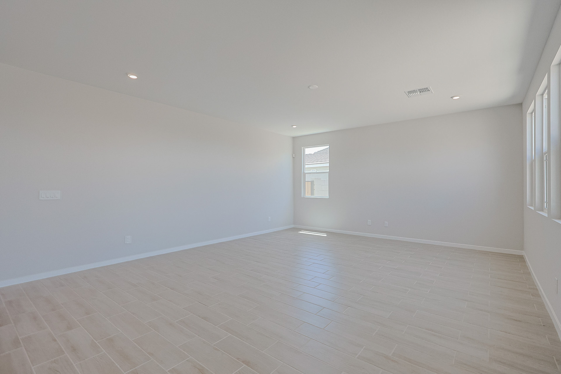A room with a wood floor and white walls.