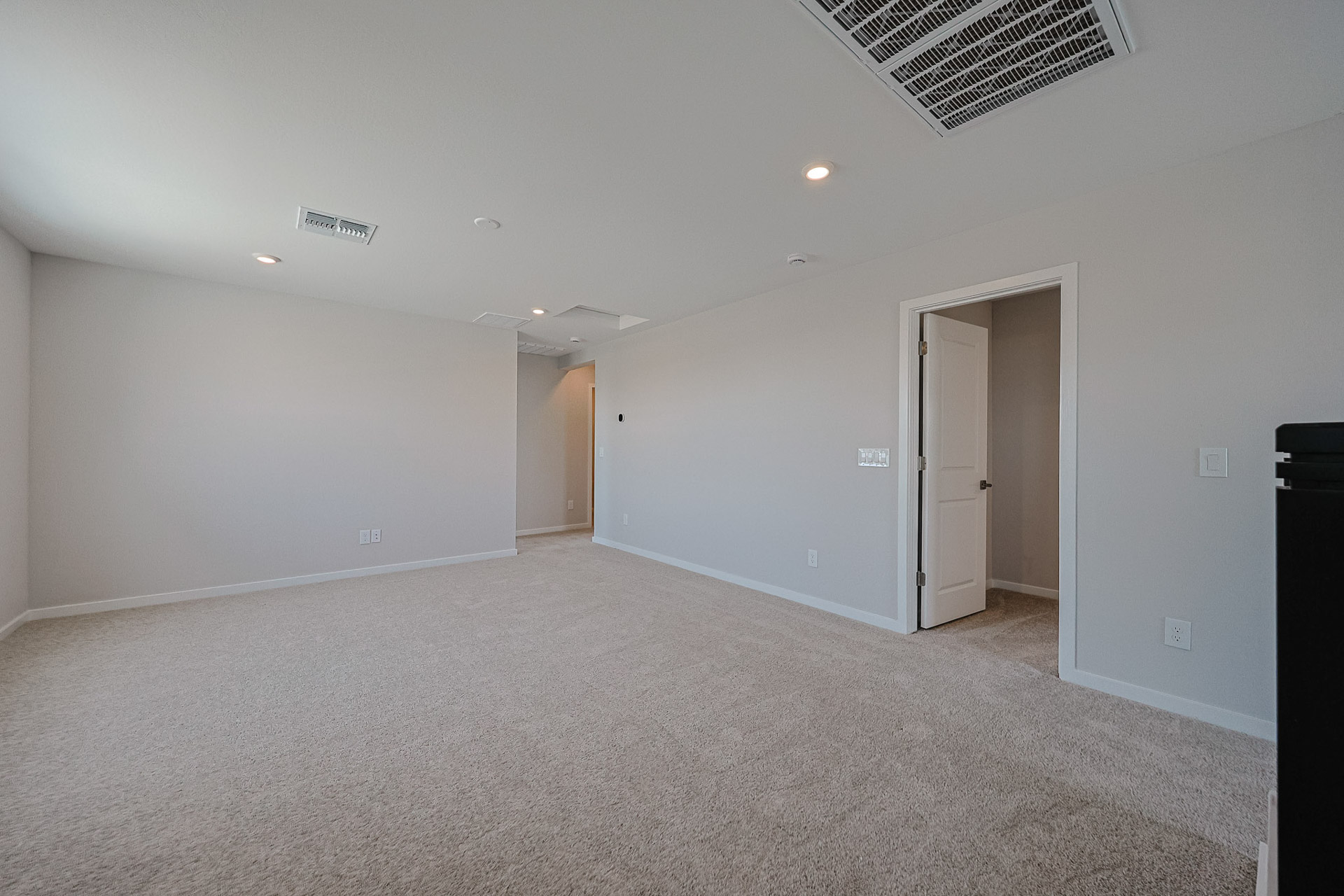 A room with white walls and a carpeted floor.