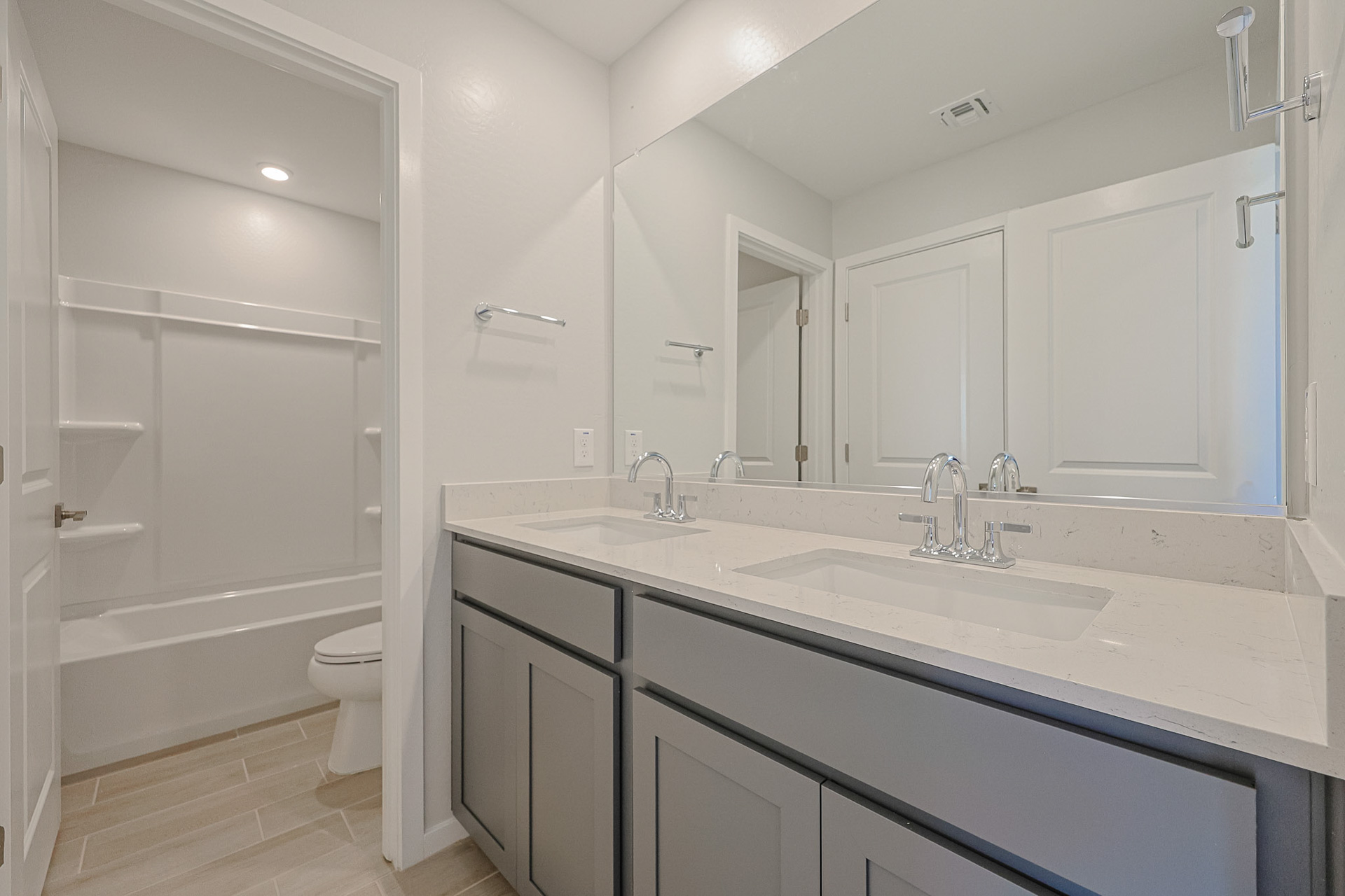 A bathroom with a sink toilet and shower.