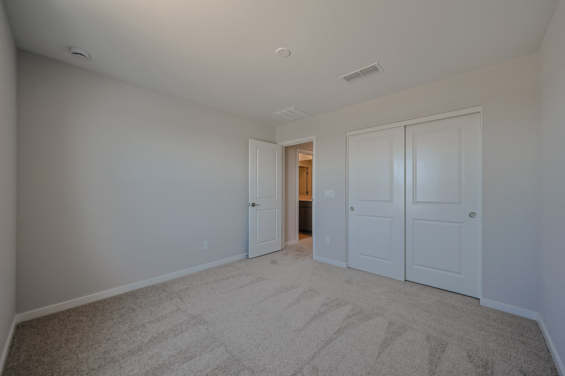 A hallway with white doors.