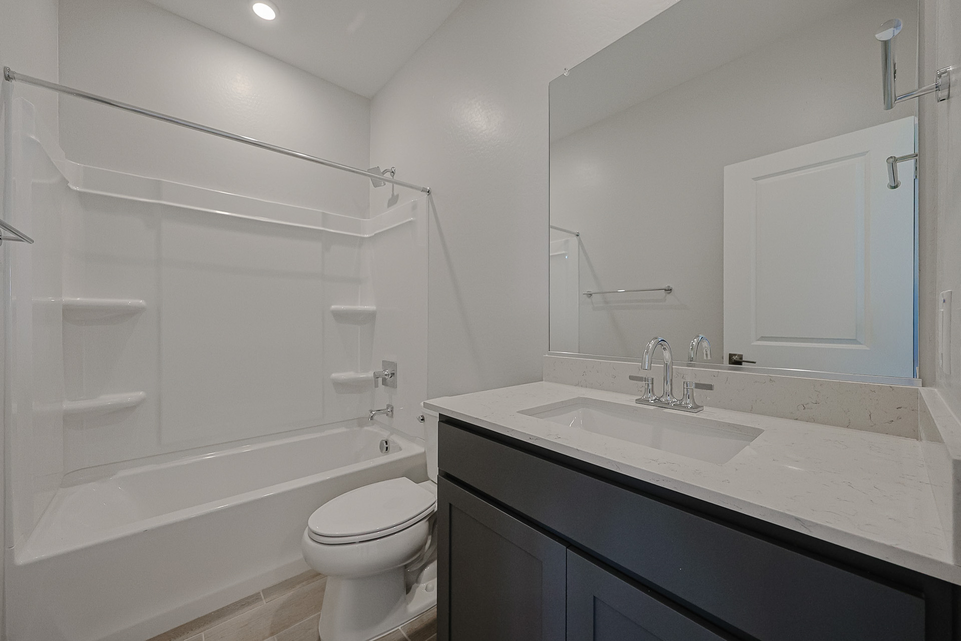 A bathroom with a tub sink and toilet.