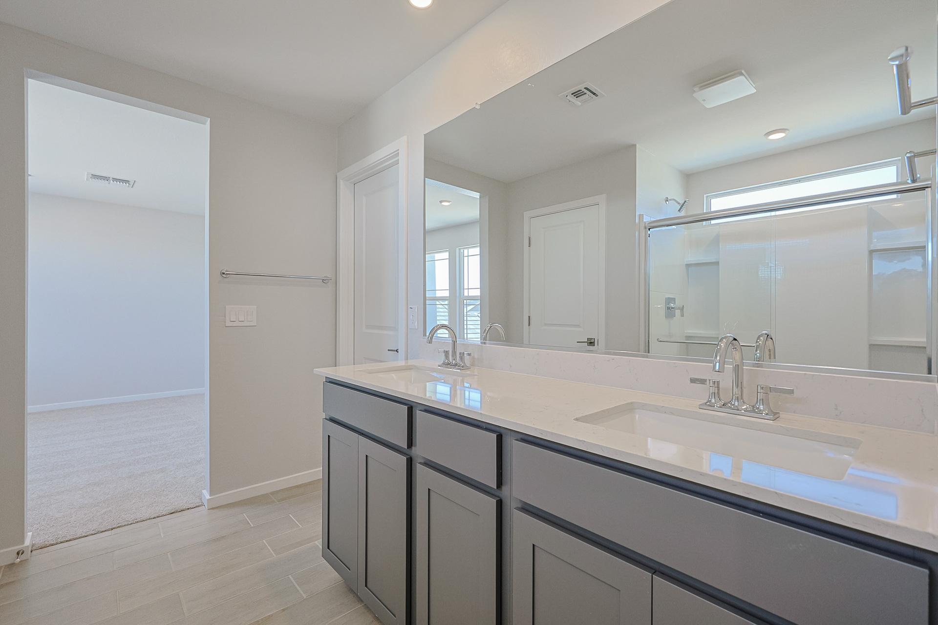 A bathroom with a large mirror.