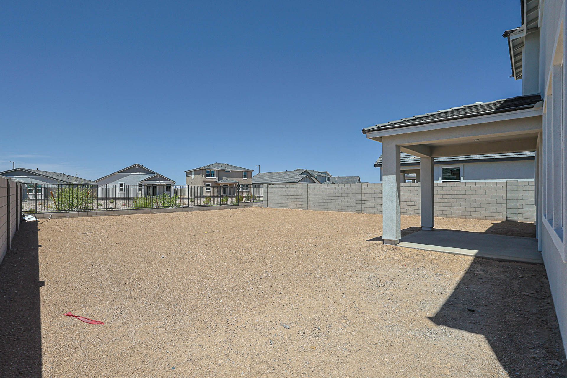 A sandy area with buildings in the background.