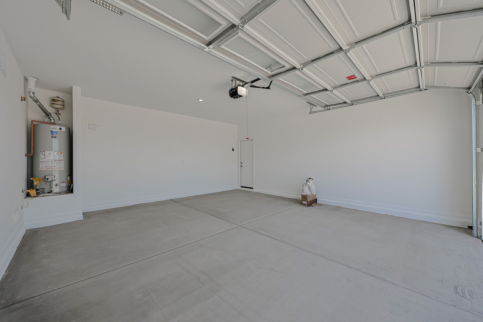 A room with white walls and a metal box on the floor.