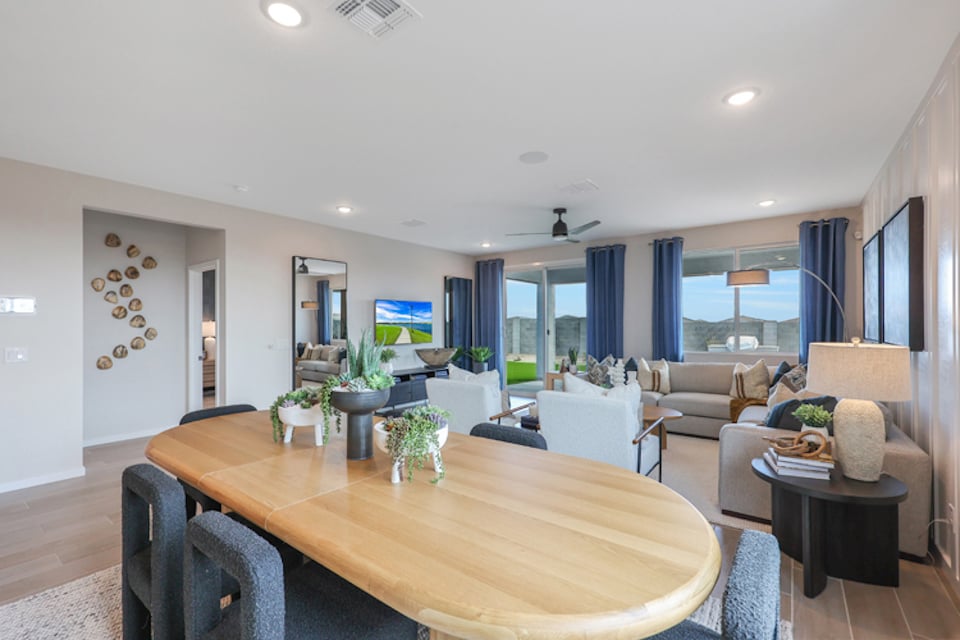 A large living room with a large table and chairs.