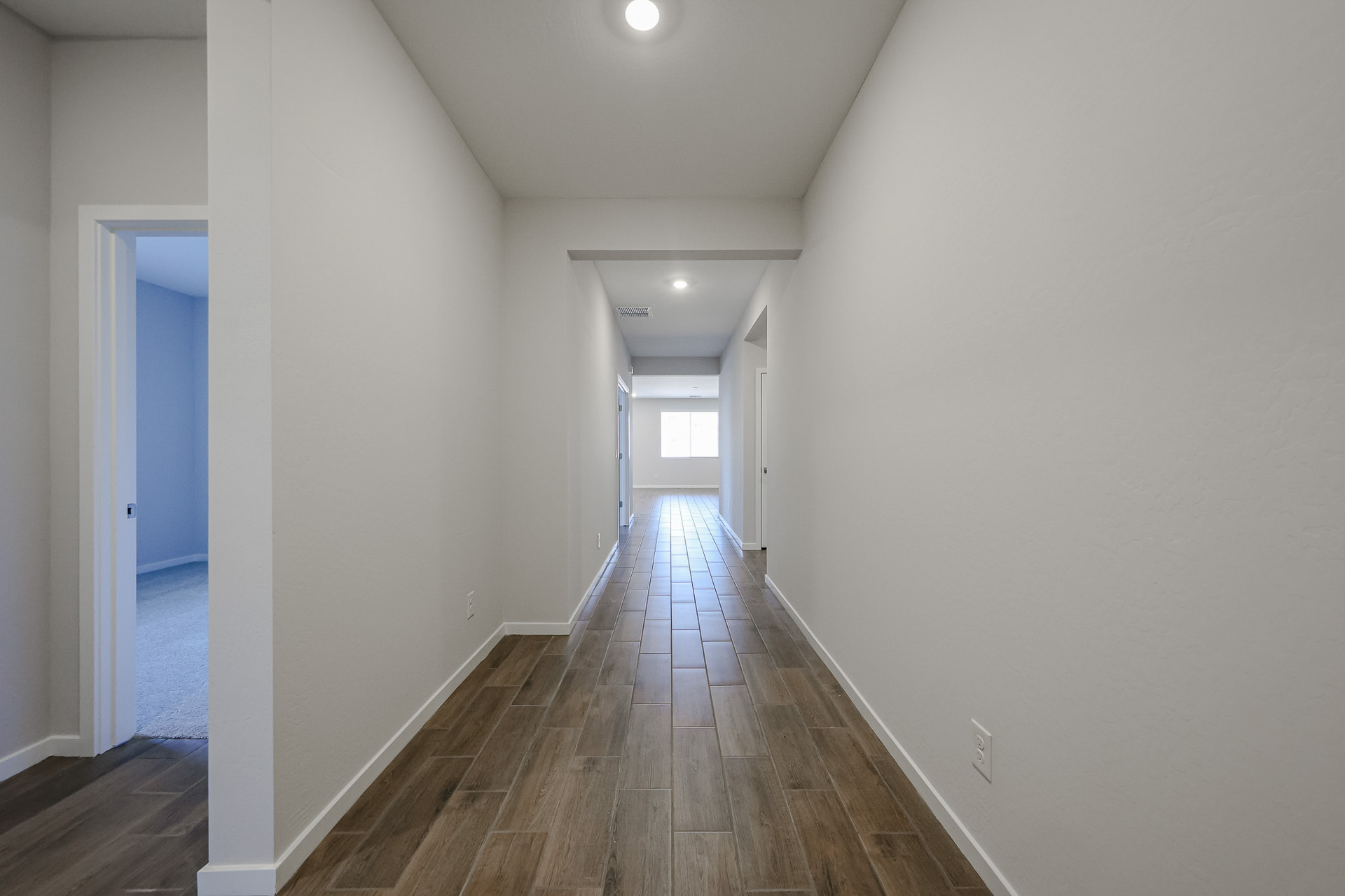 A long hallway with white walls.