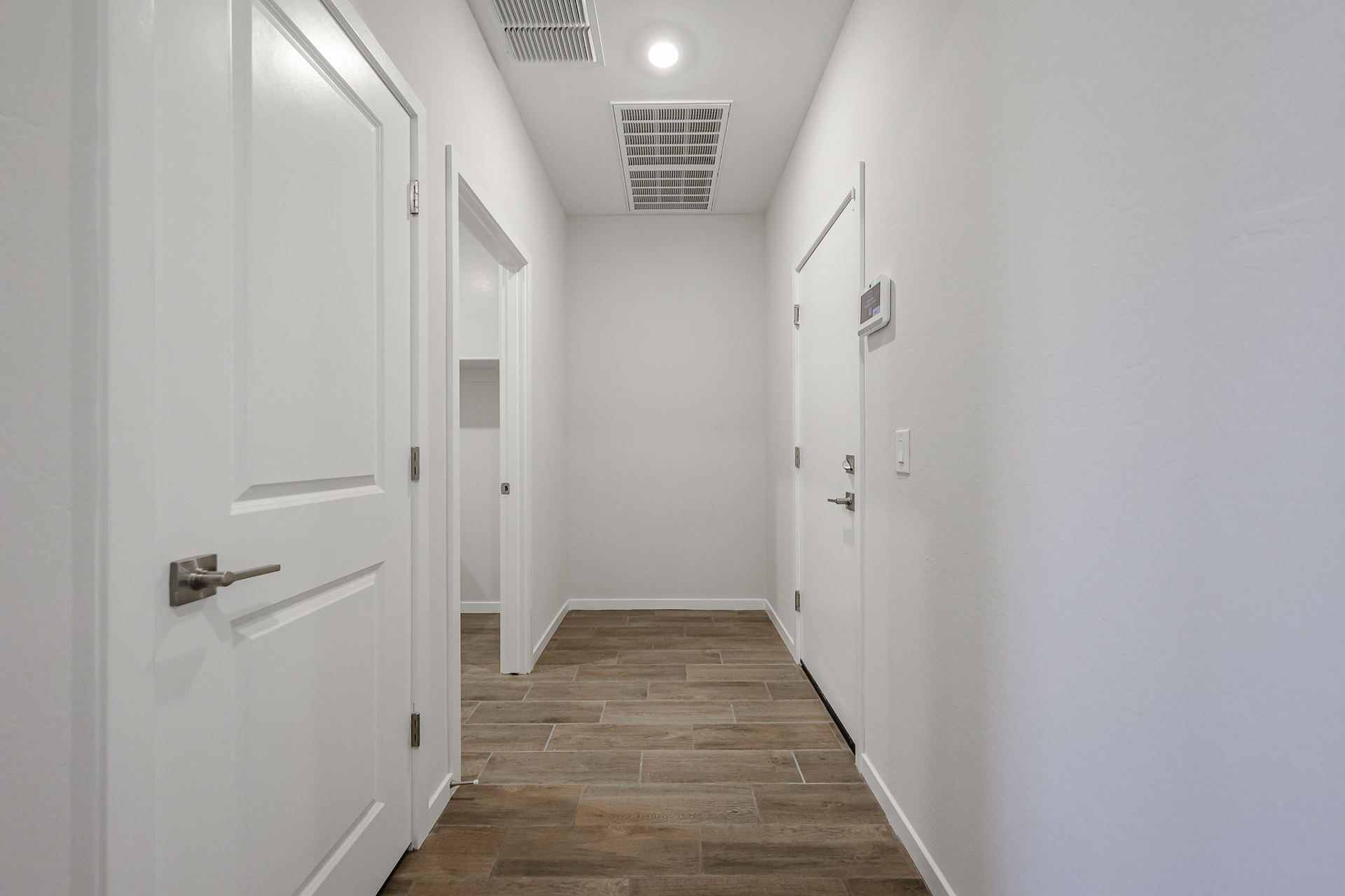 A hallway with white doors.