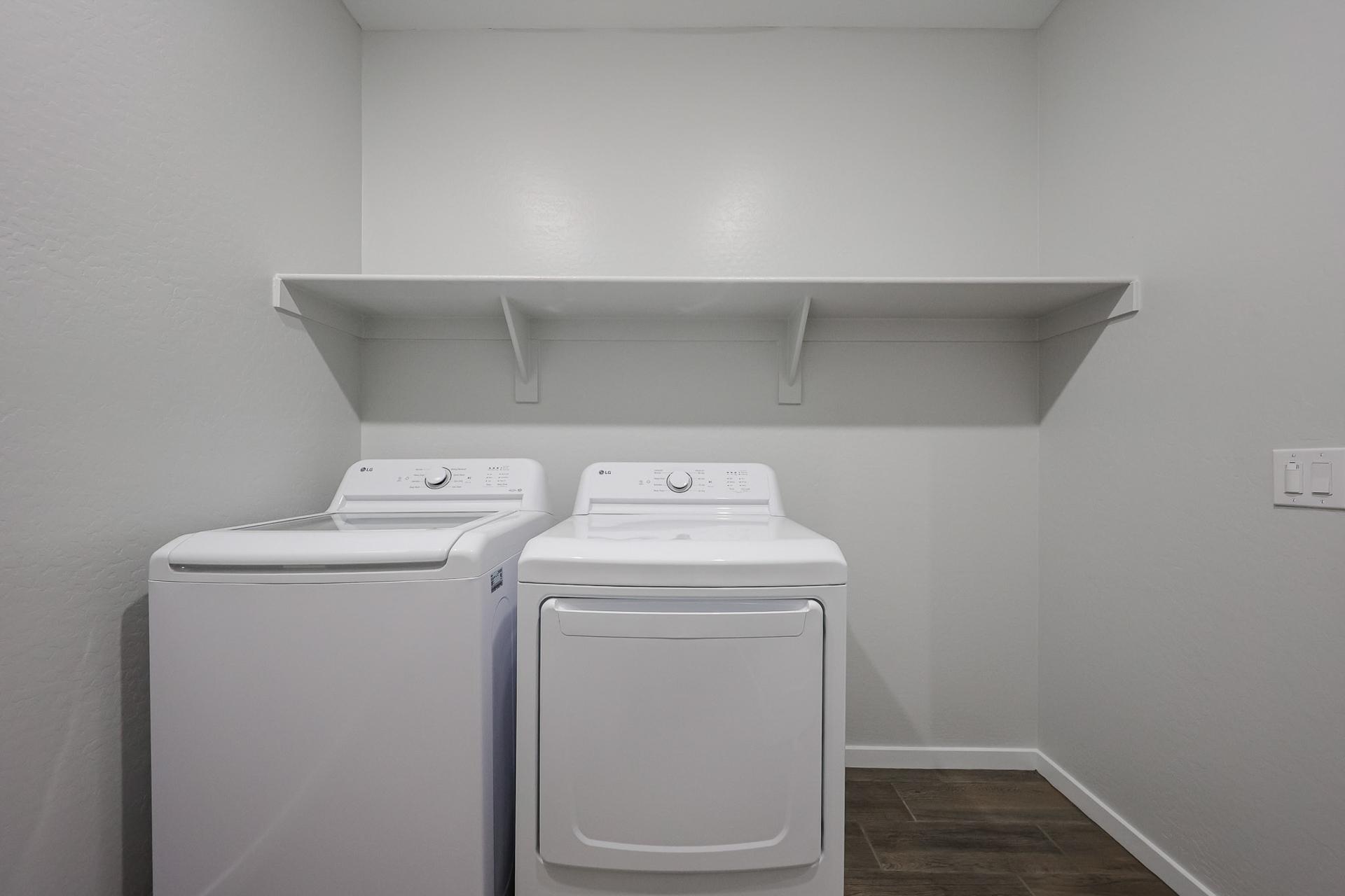 A washing machine and dryer in a room.