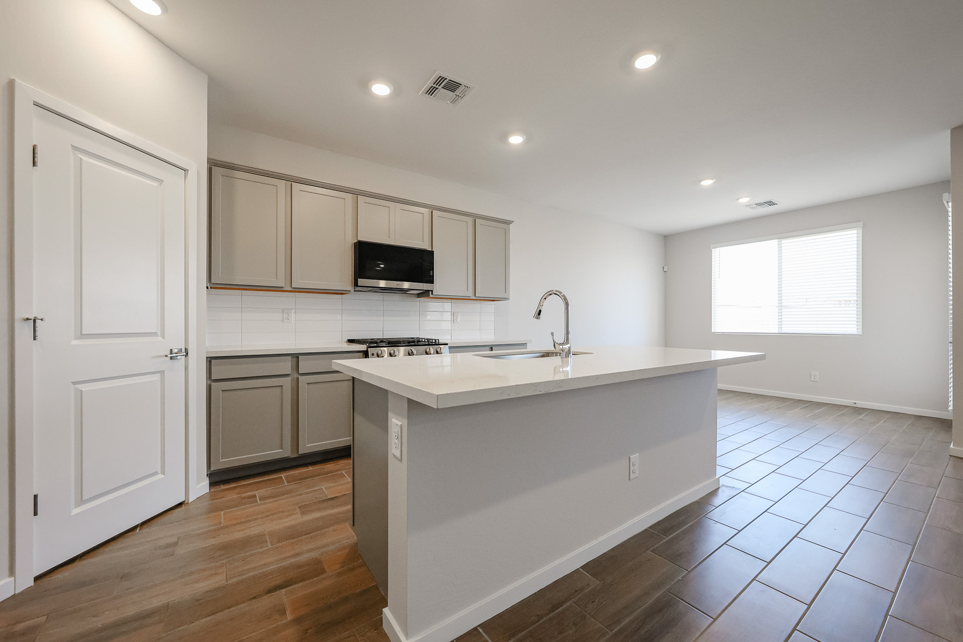 A kitchen with white cabinets.