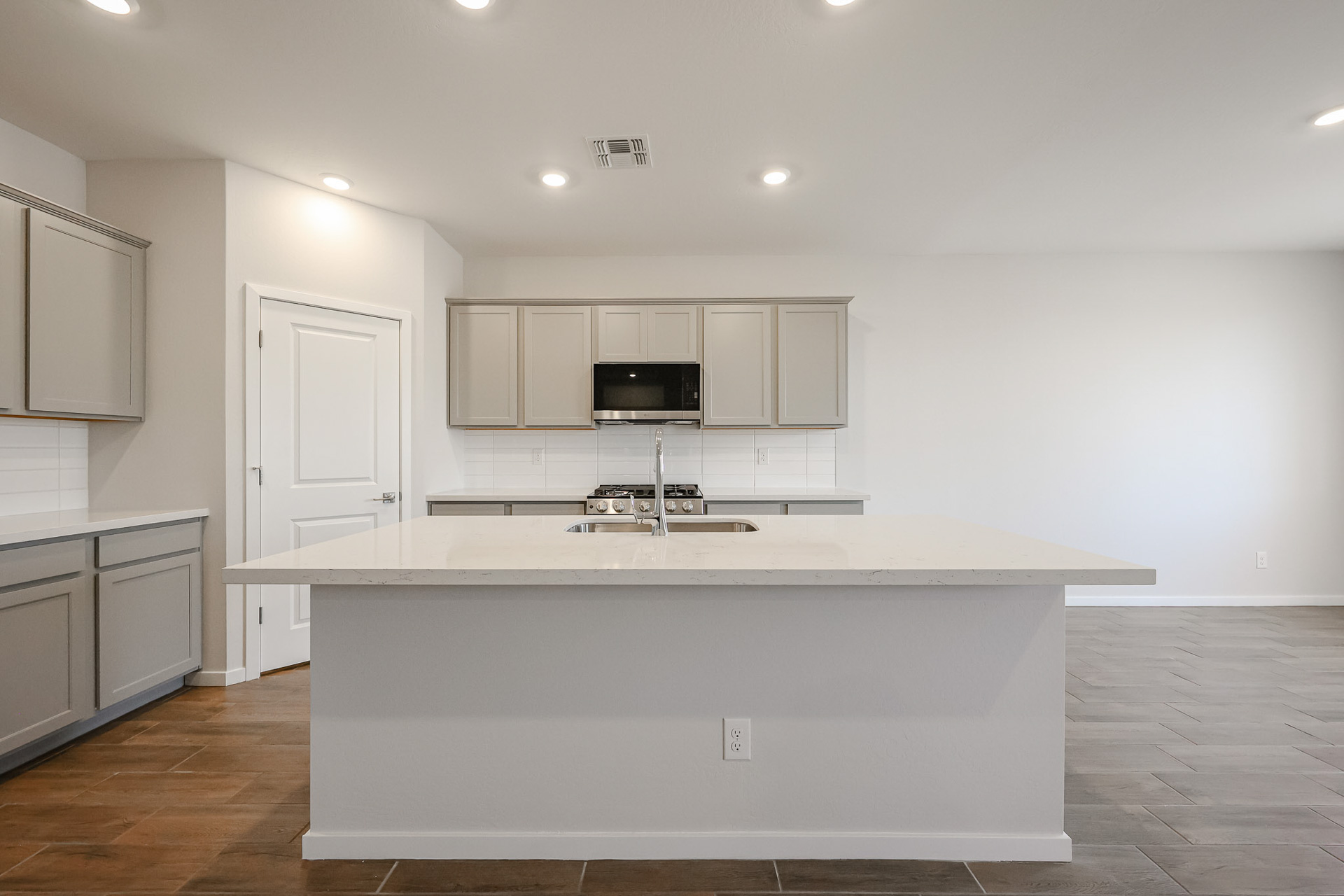A kitchen with white cabinets.