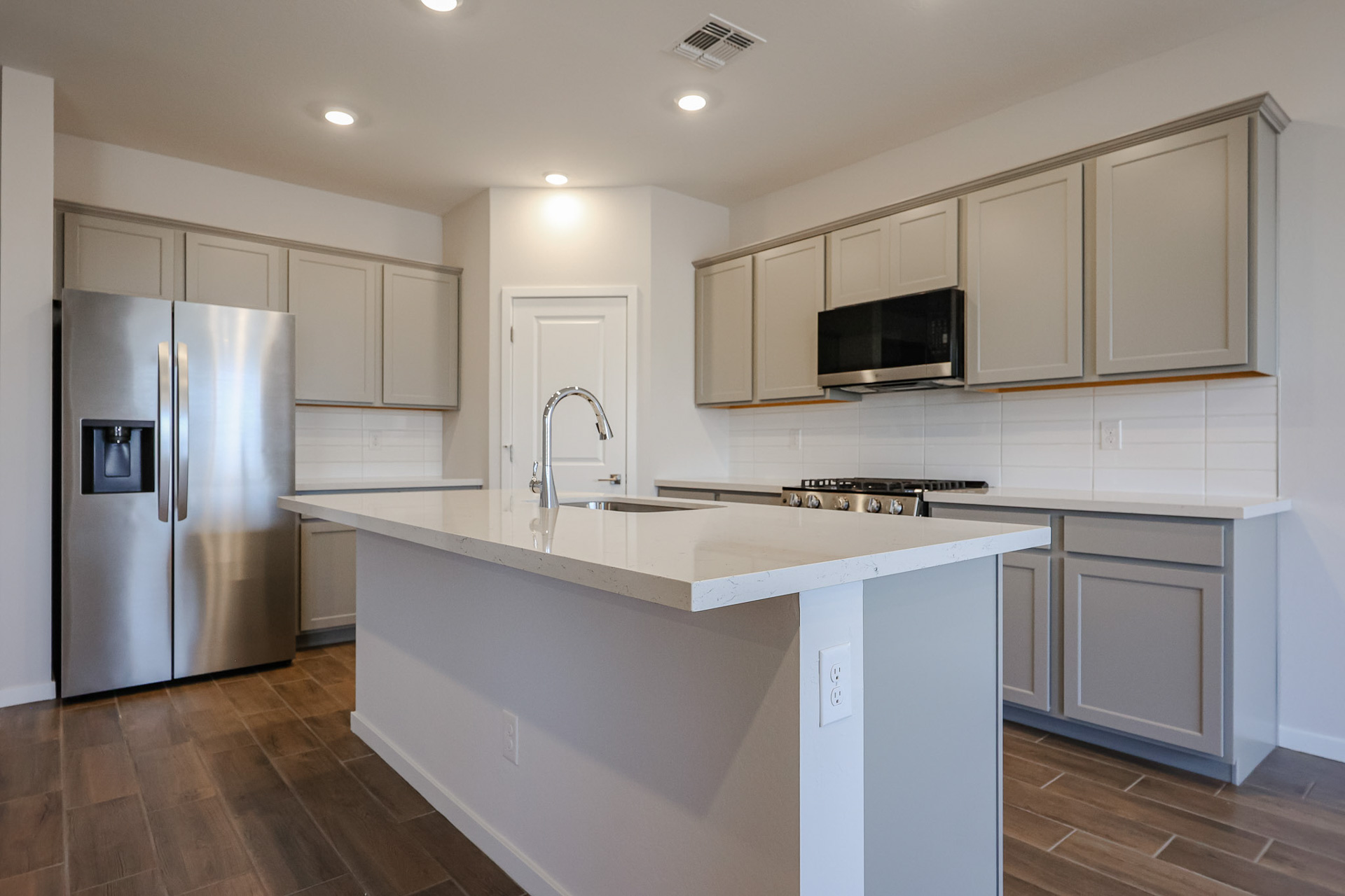 A kitchen with white cabinets.