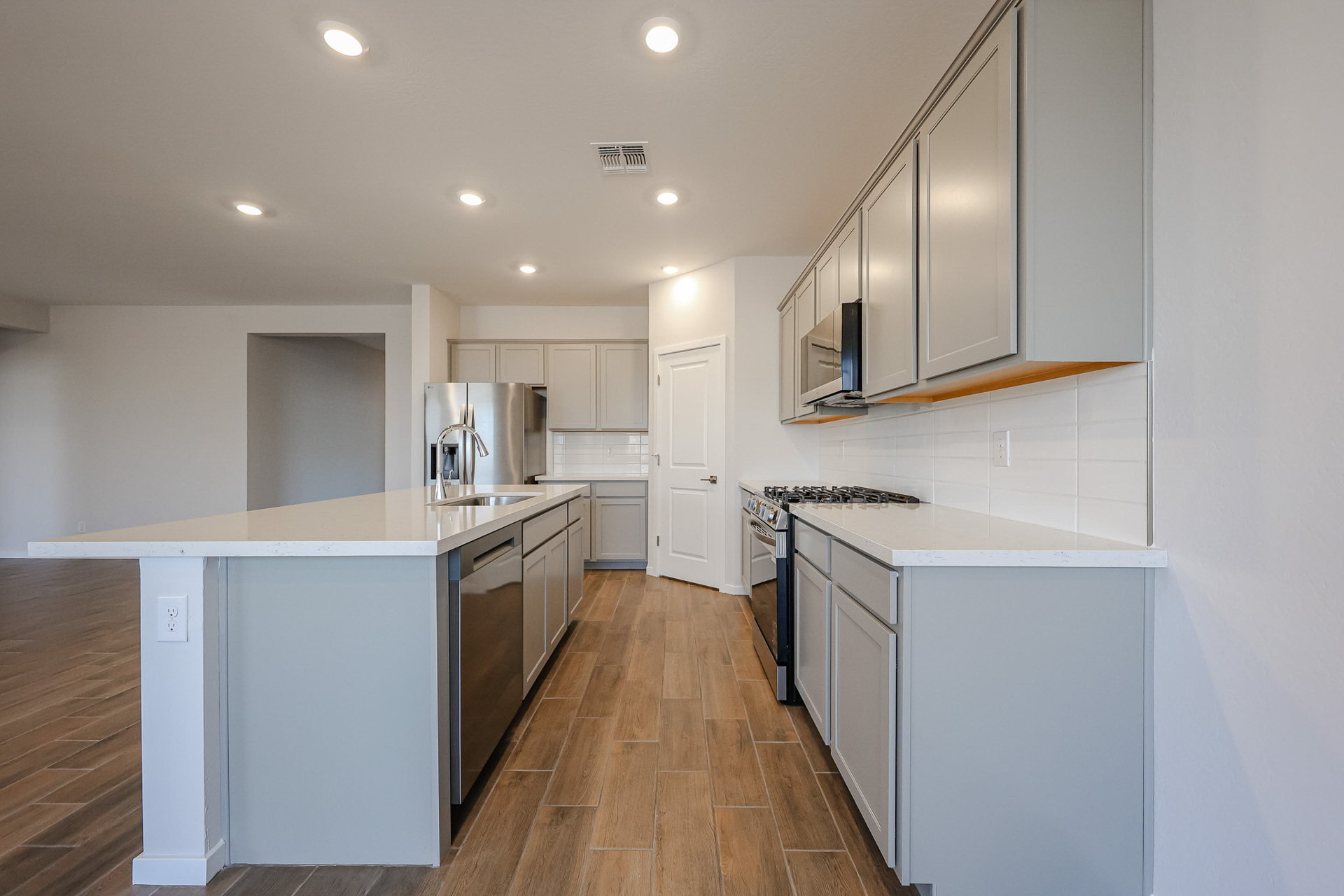 A kitchen with white cabinets.