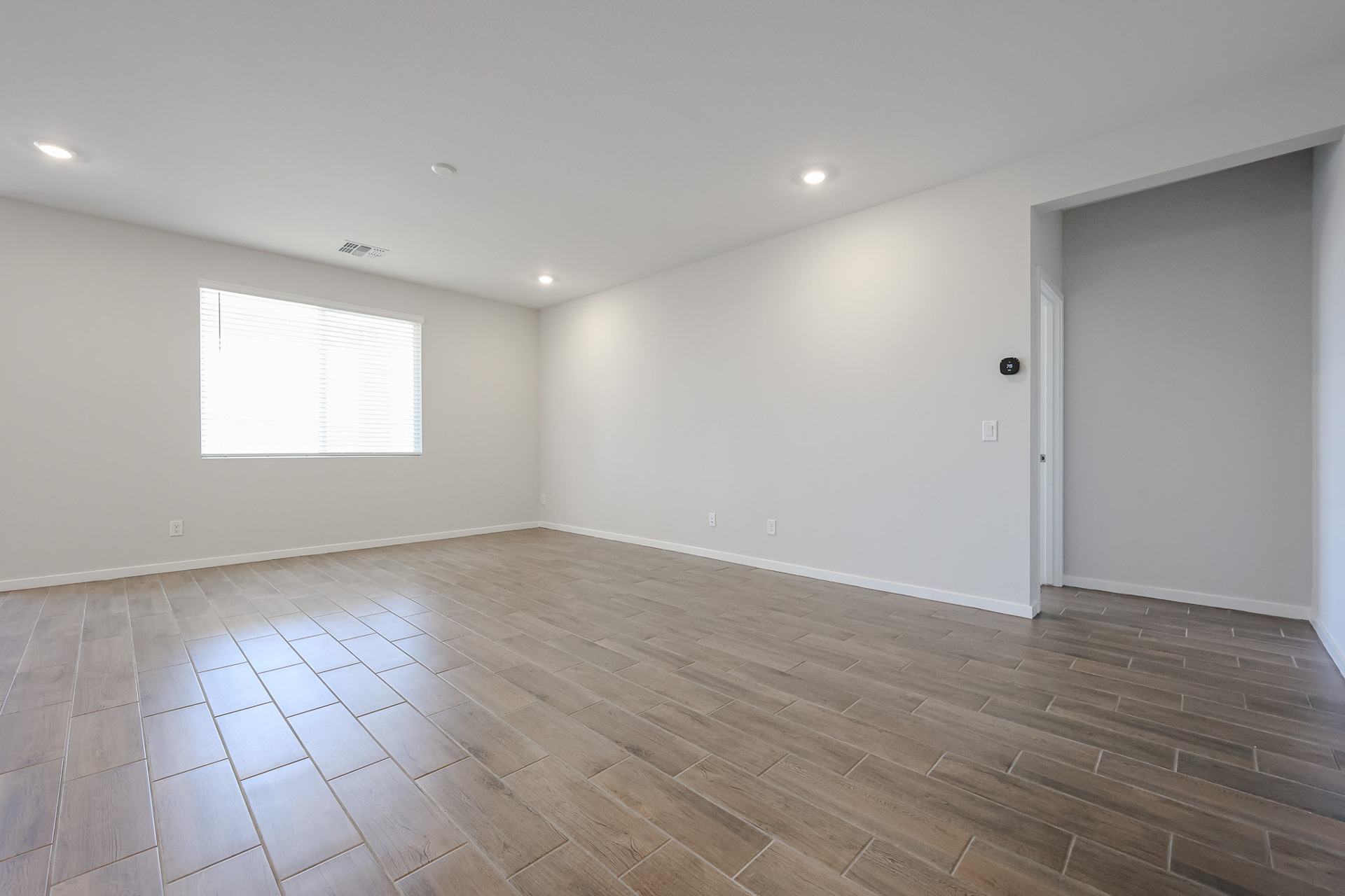 A room with a wood floor and white doors.