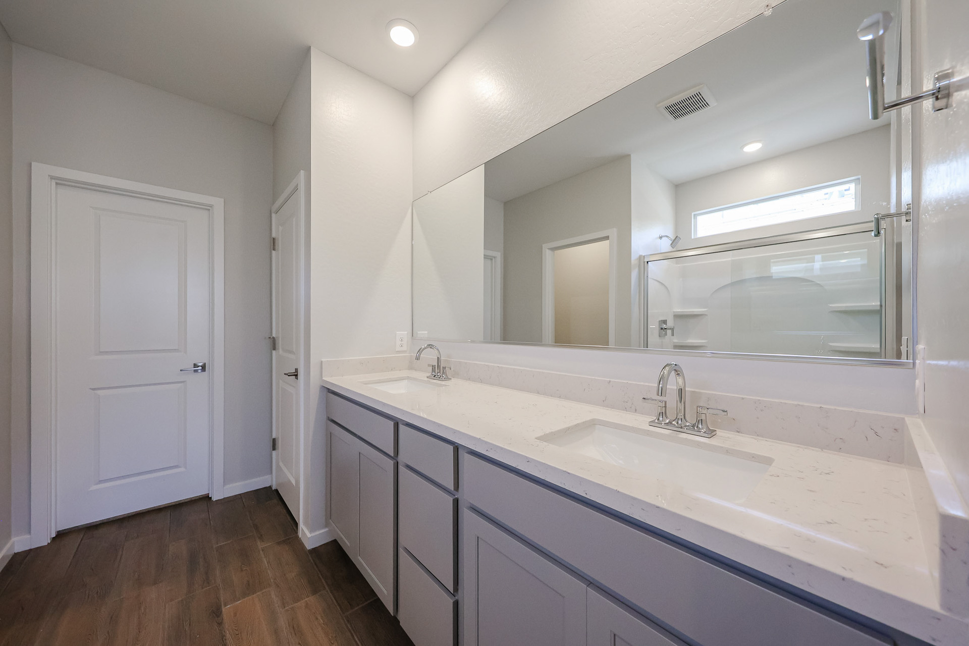 A bathroom with a large mirror.