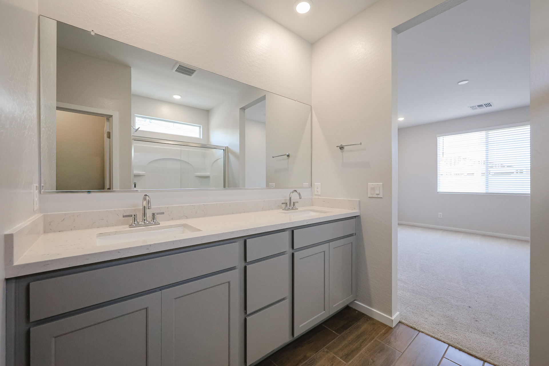 A bathroom with a large mirror.