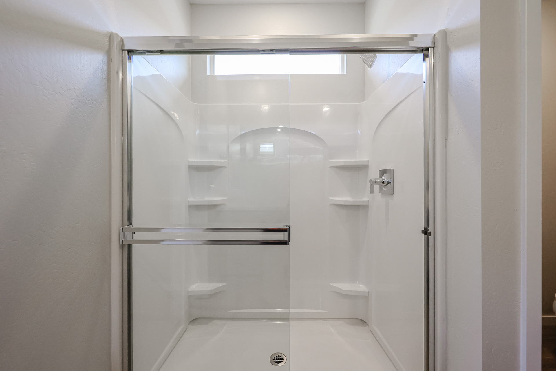 A shower with a glass door.