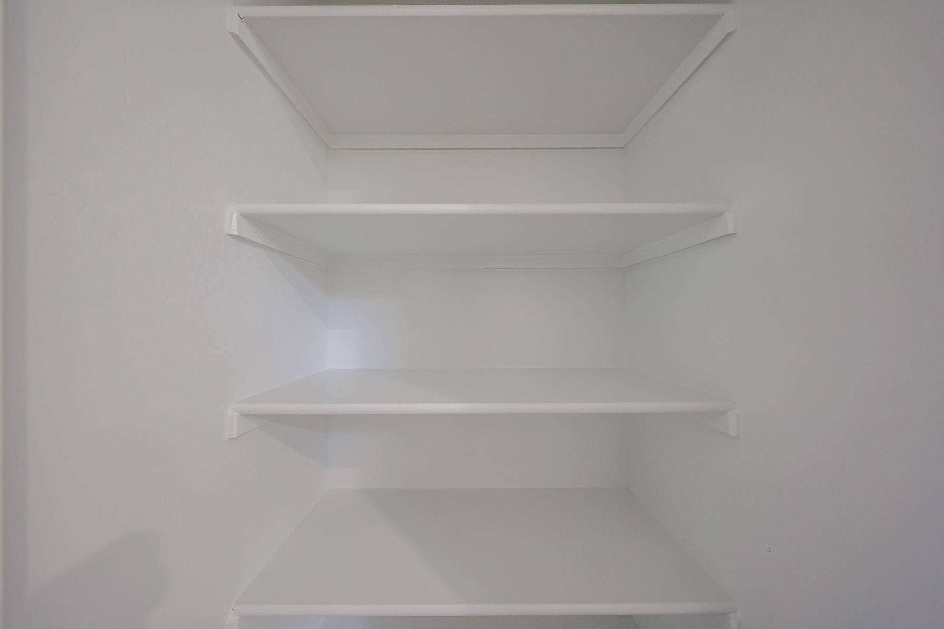 A white shelf with a light.