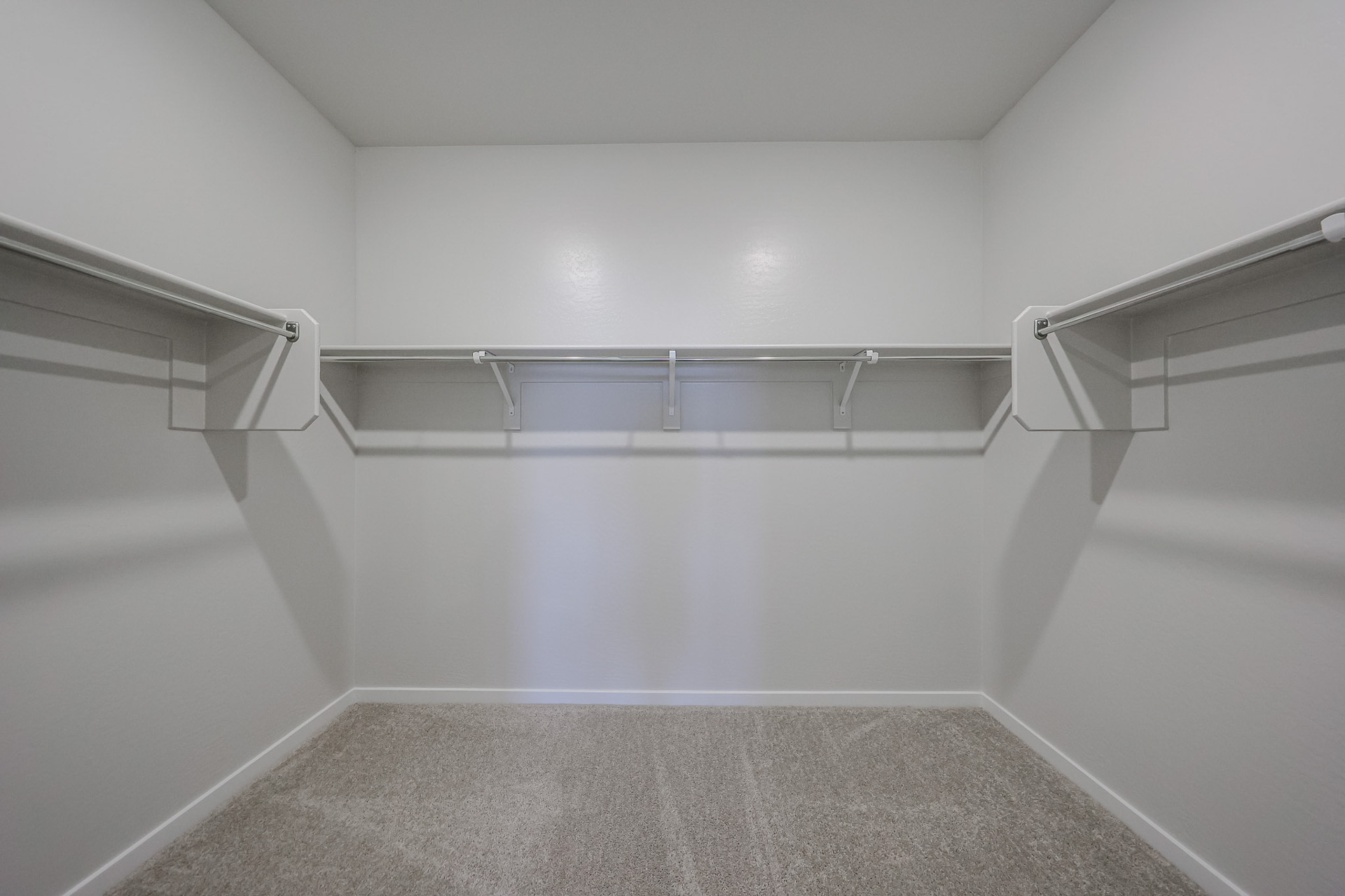 A white room with a metal railing.