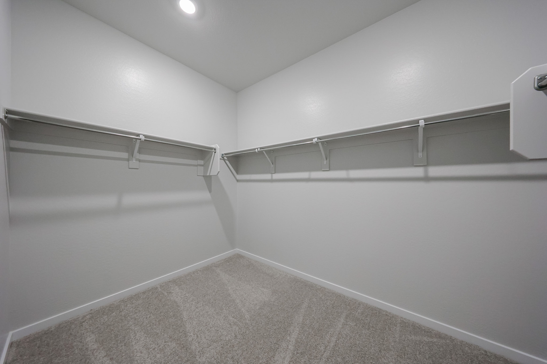 A white wall with a metal railing.