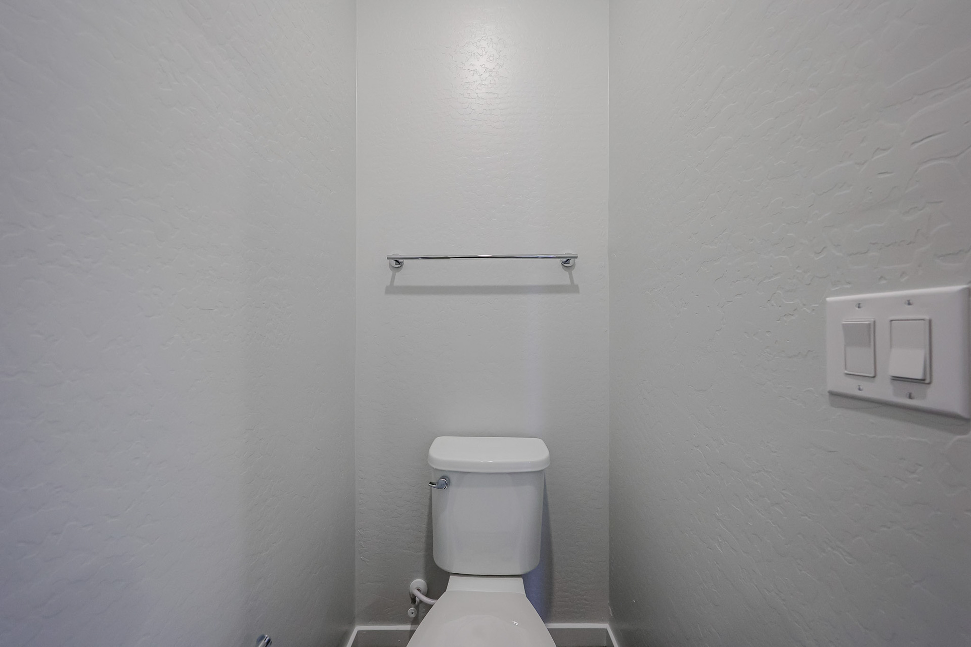 A toilet in a bathroom.