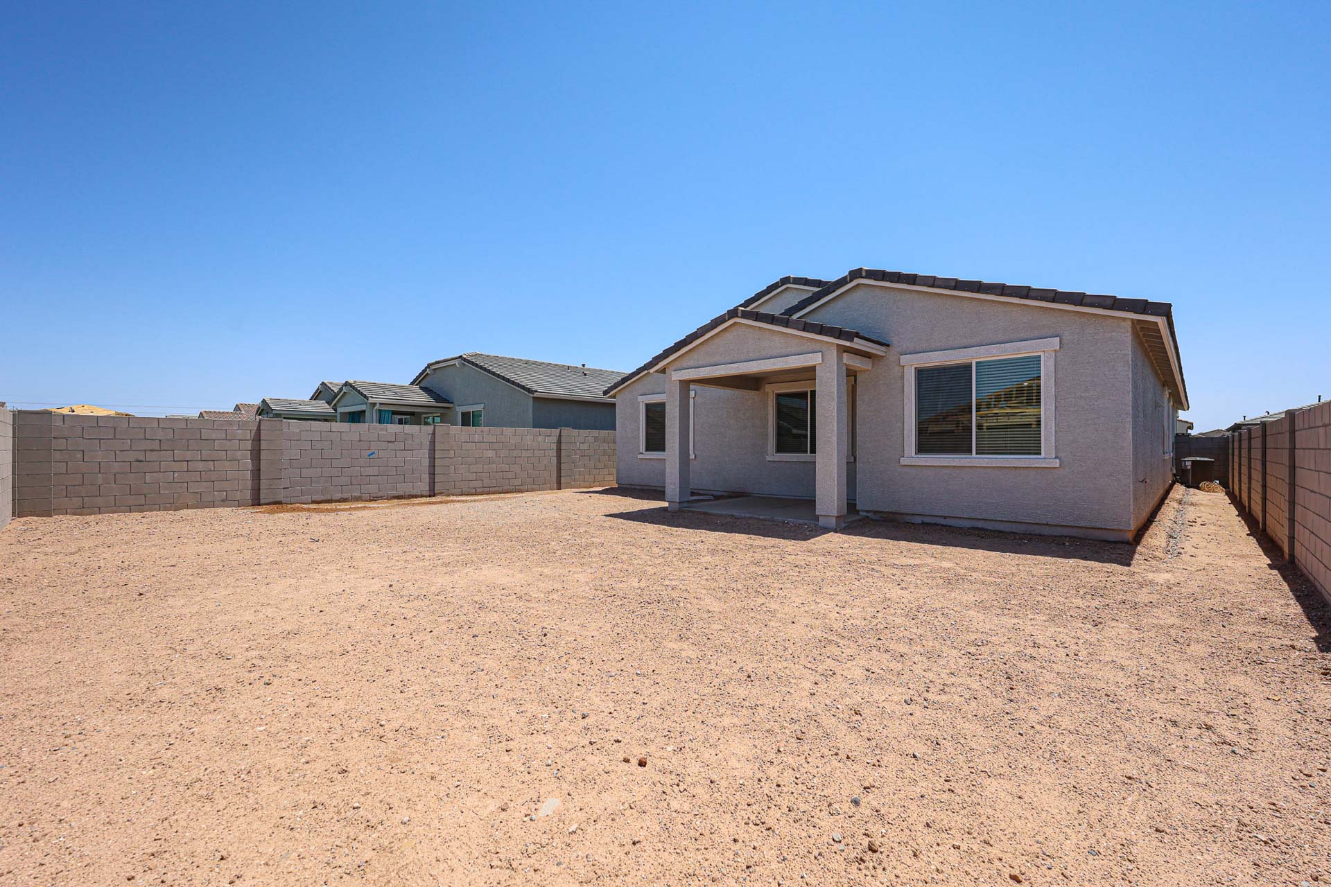 A house in a dirt field.