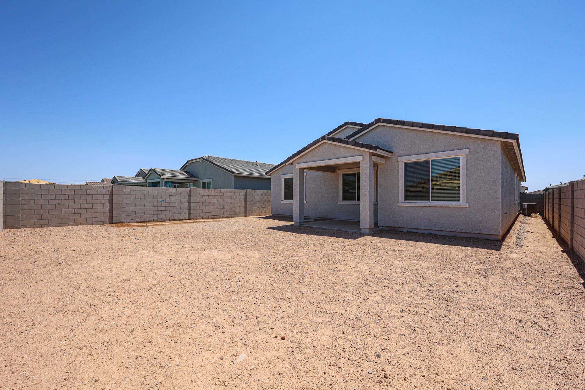 A house in a dirt field.