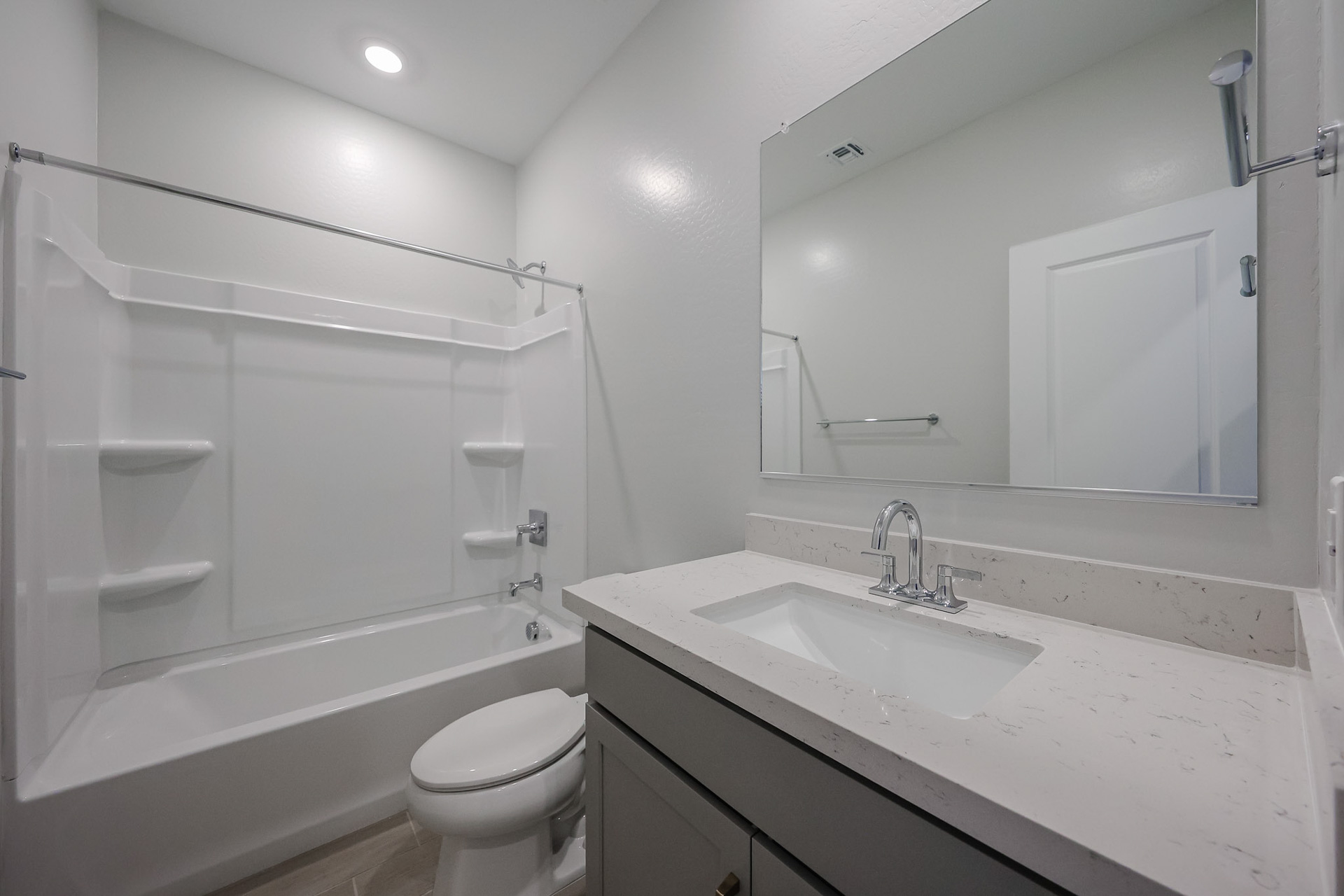 A bathroom with a sink toilet and bathtub.