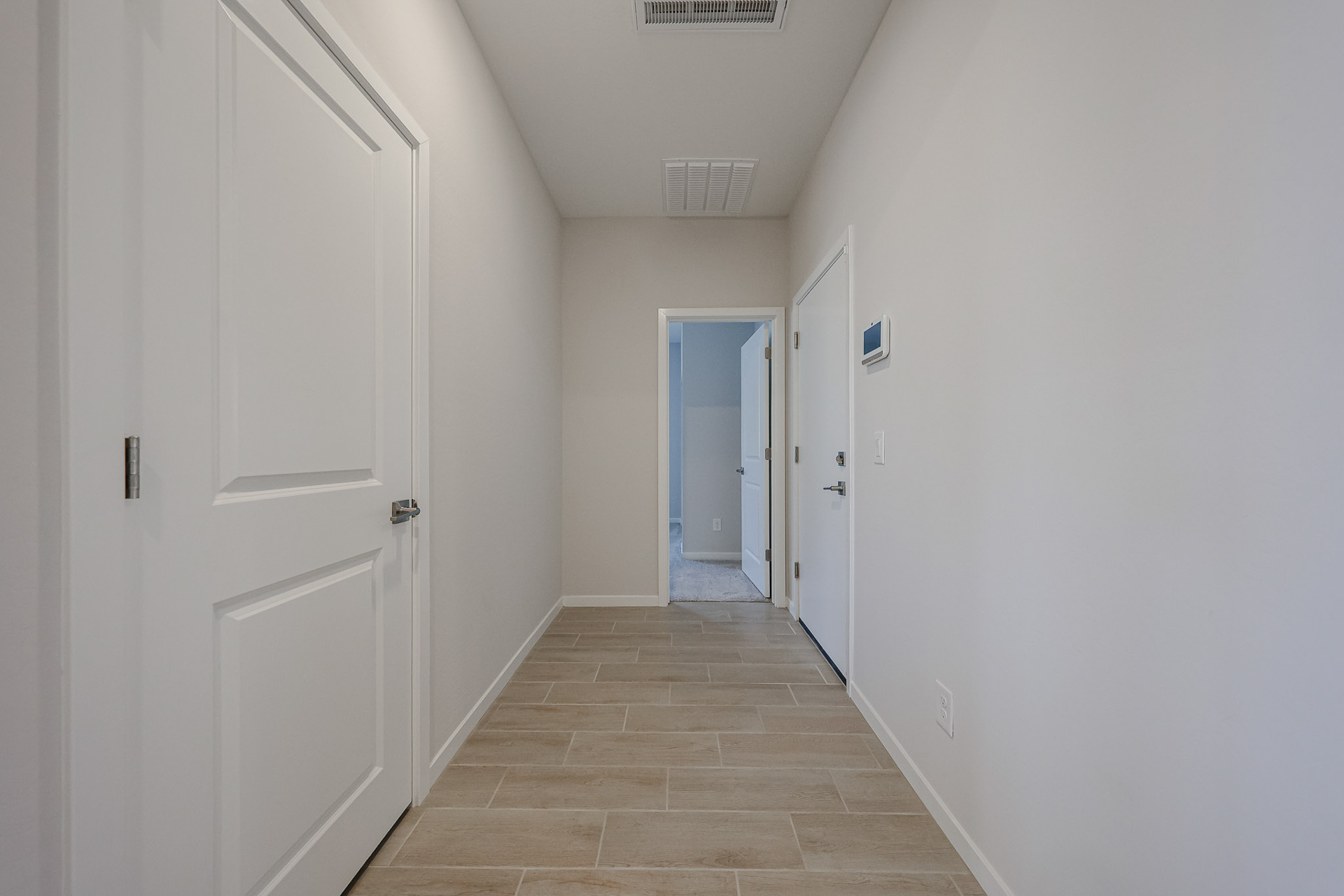 A hallway with white doors.