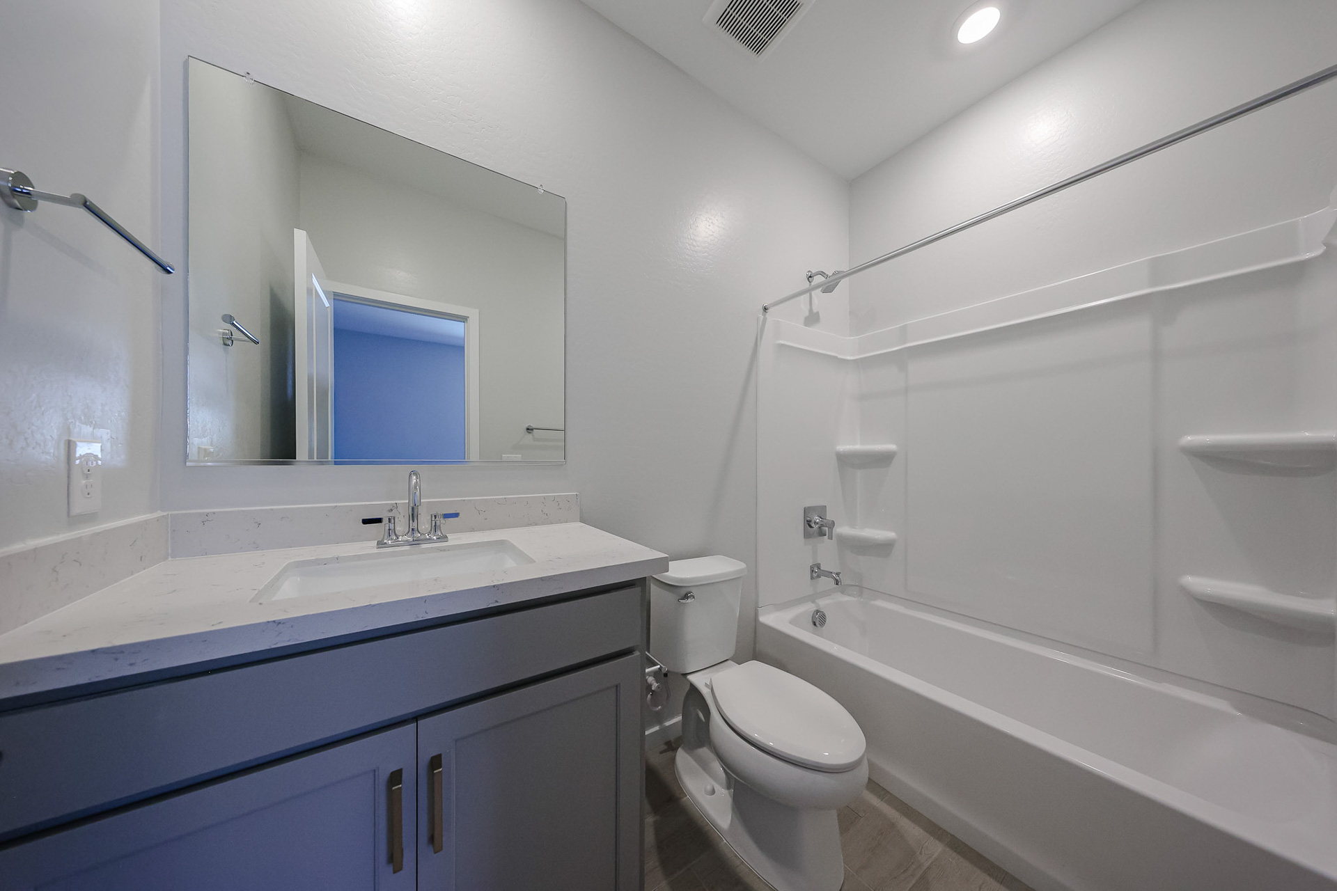 A bathroom with a tub sink and toilet.