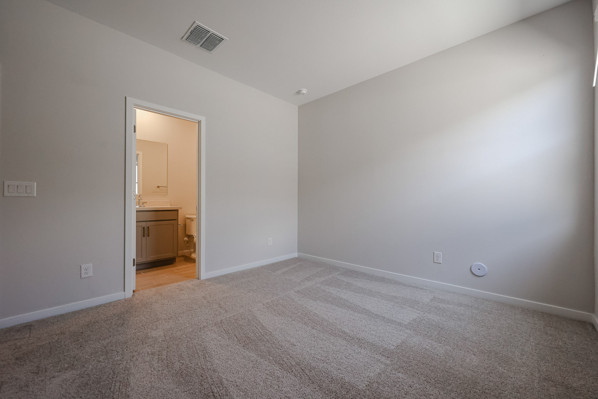 A room with a door and a mirror.