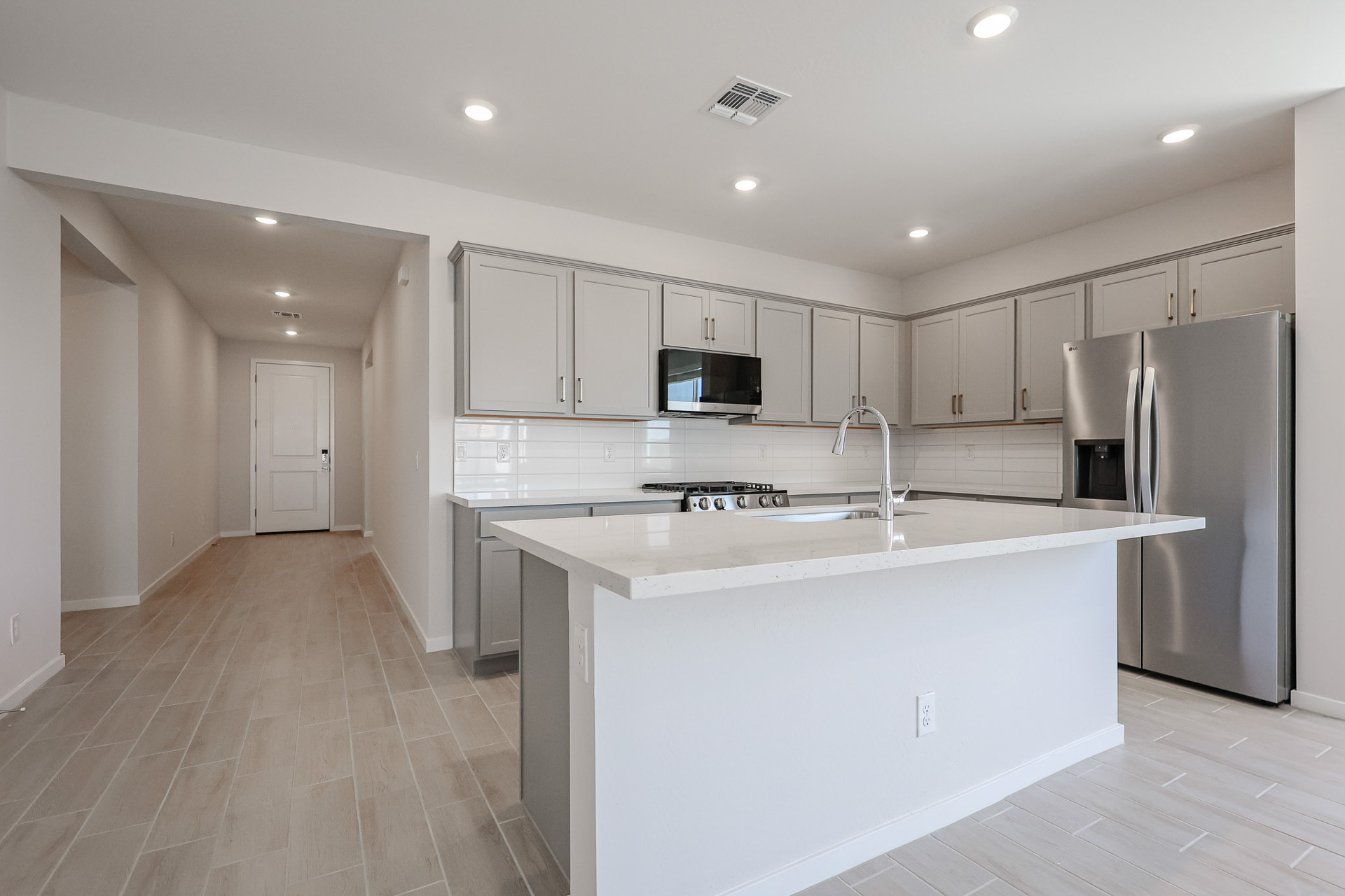A kitchen with white cabinets.