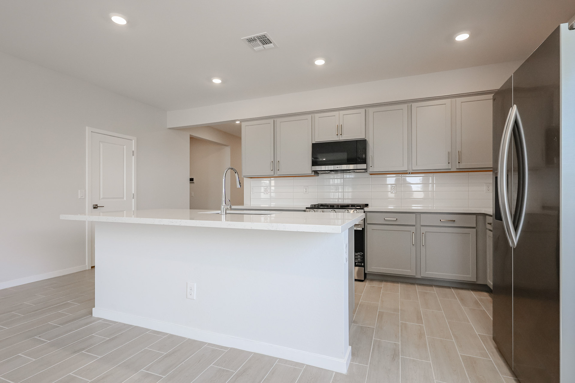 A kitchen with white cabinets.