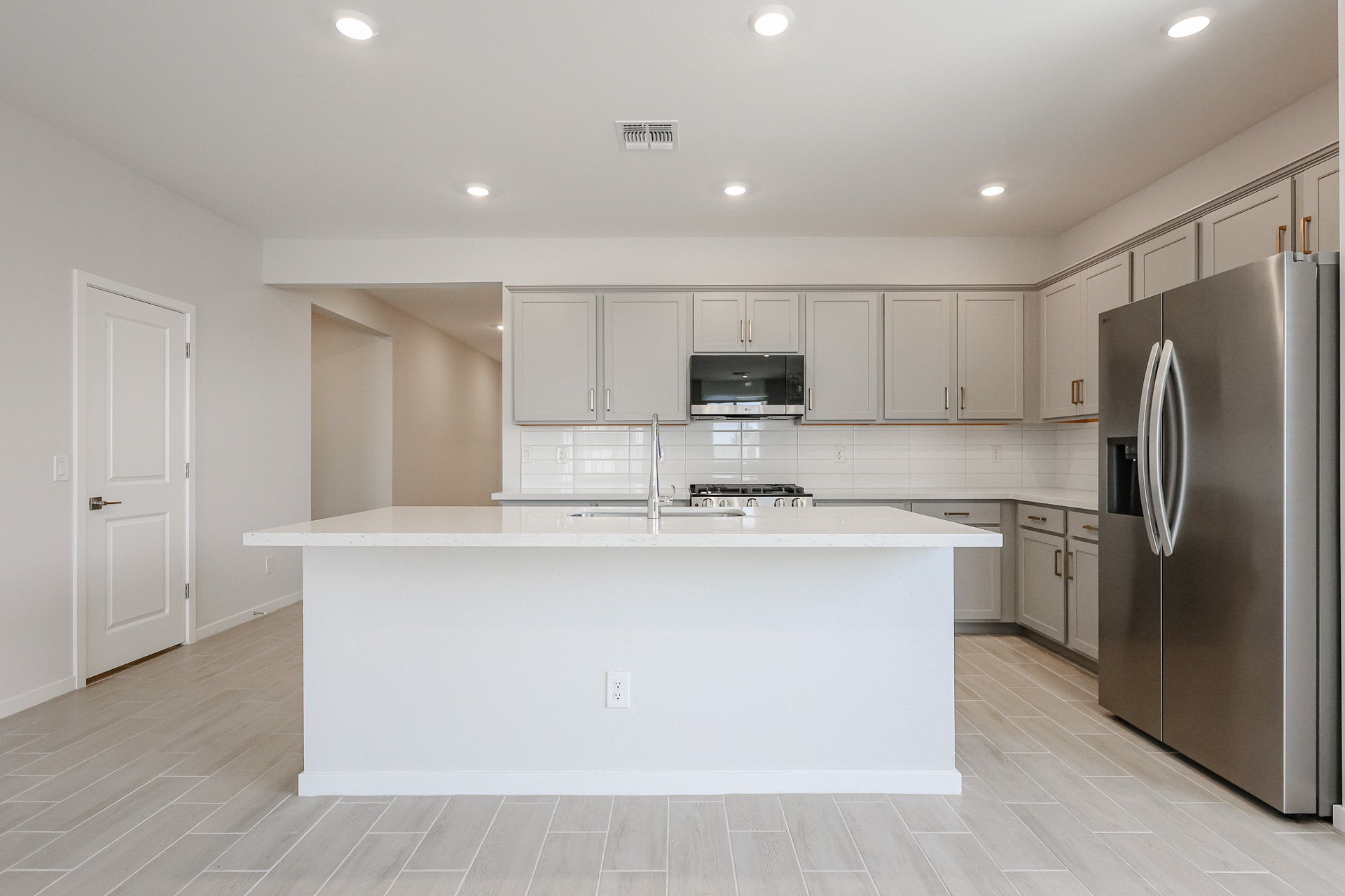 A kitchen with white cabinets.
