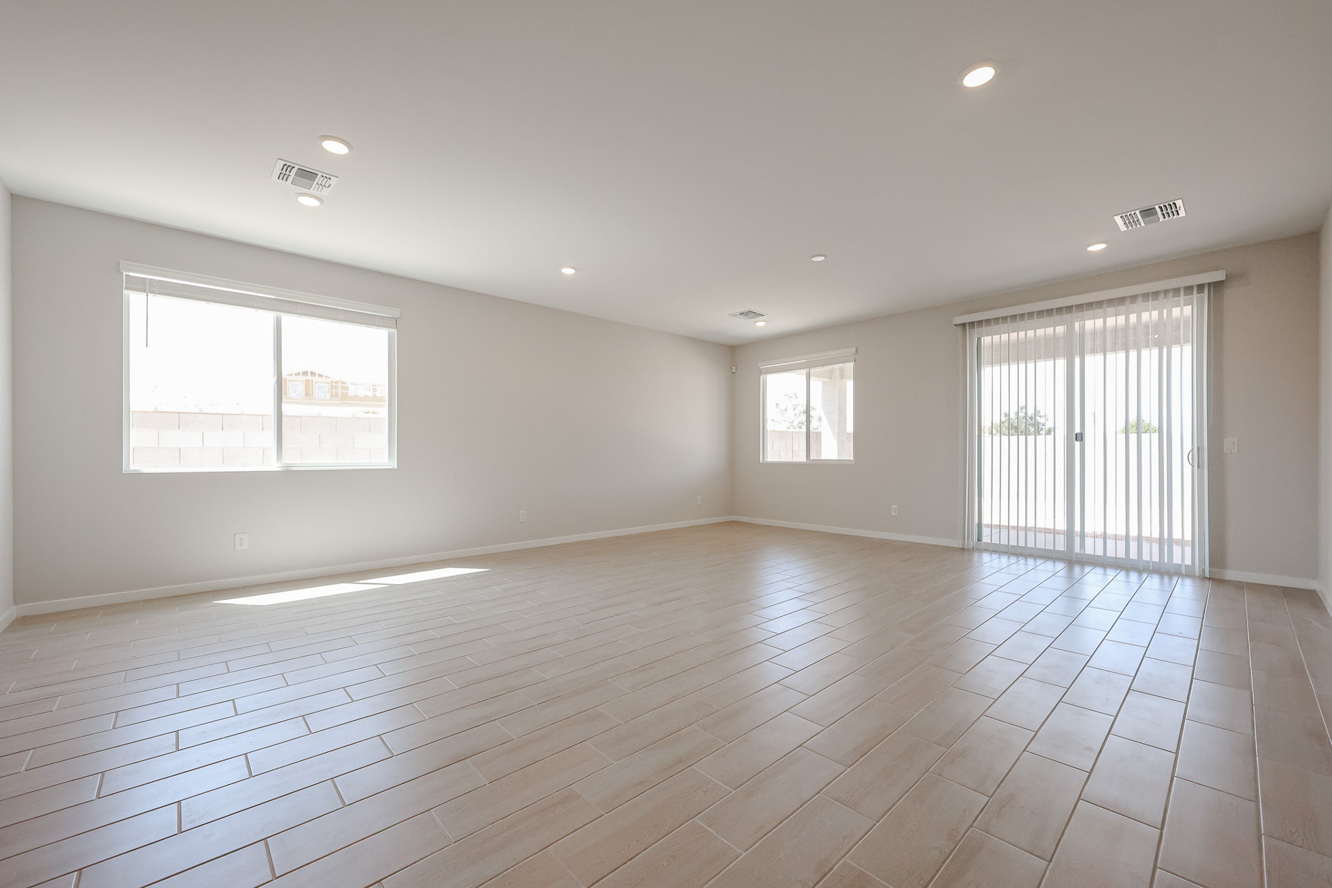 A room with a wood floor and windows.
