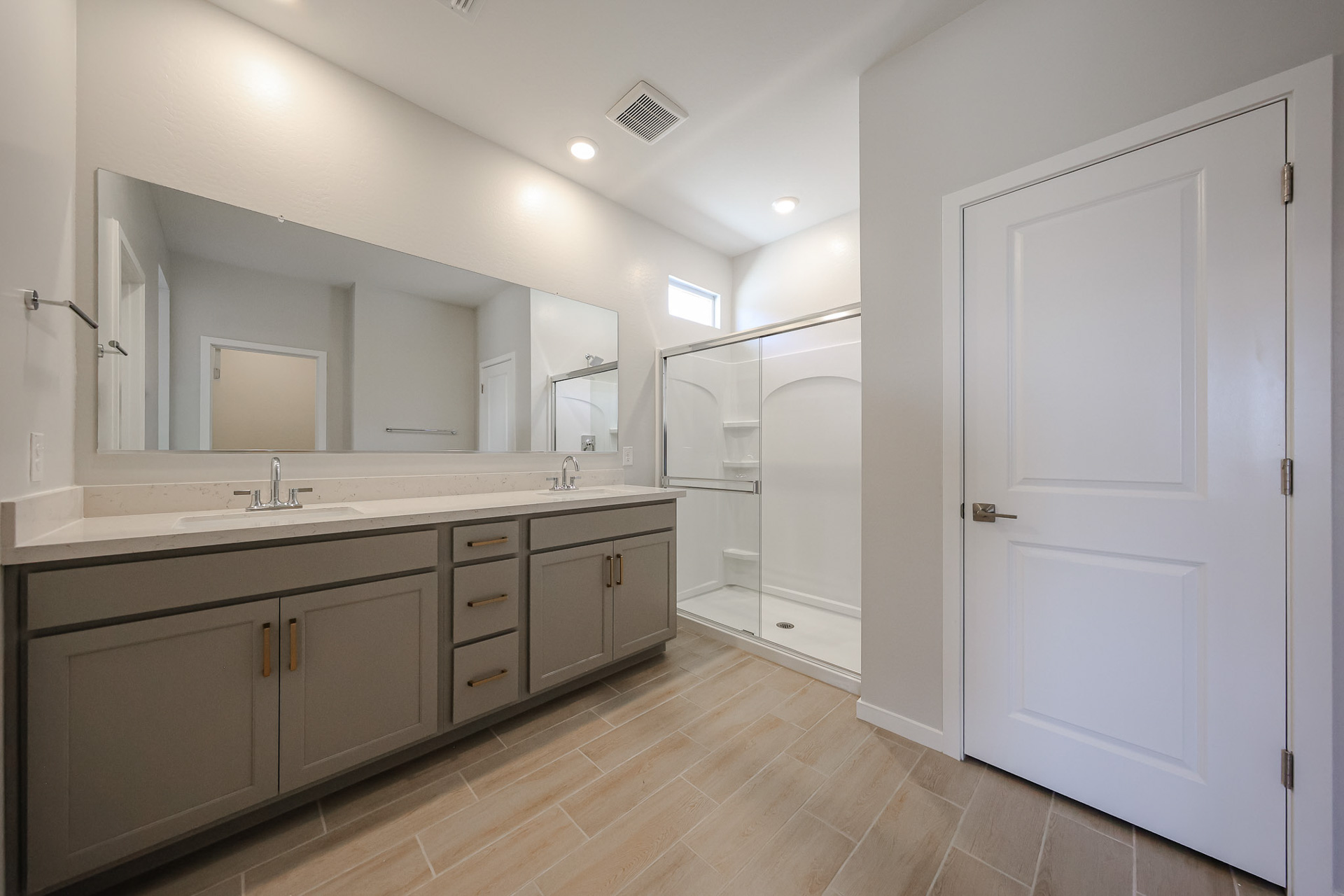 A bathroom with a large mirror.