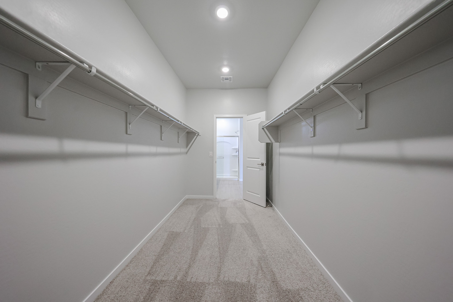 A long hallway with white walls.