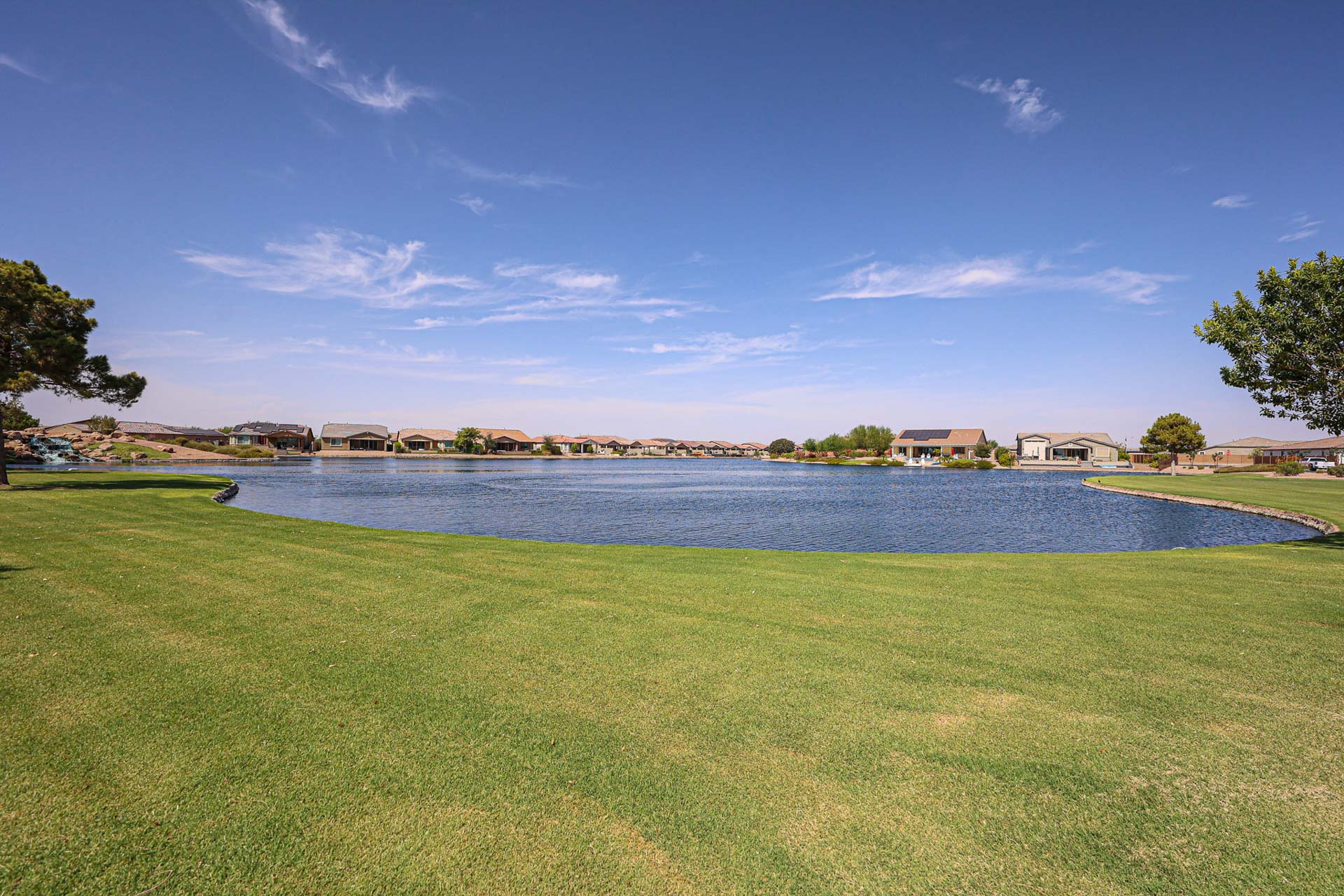 A golf course next to a body of water.
