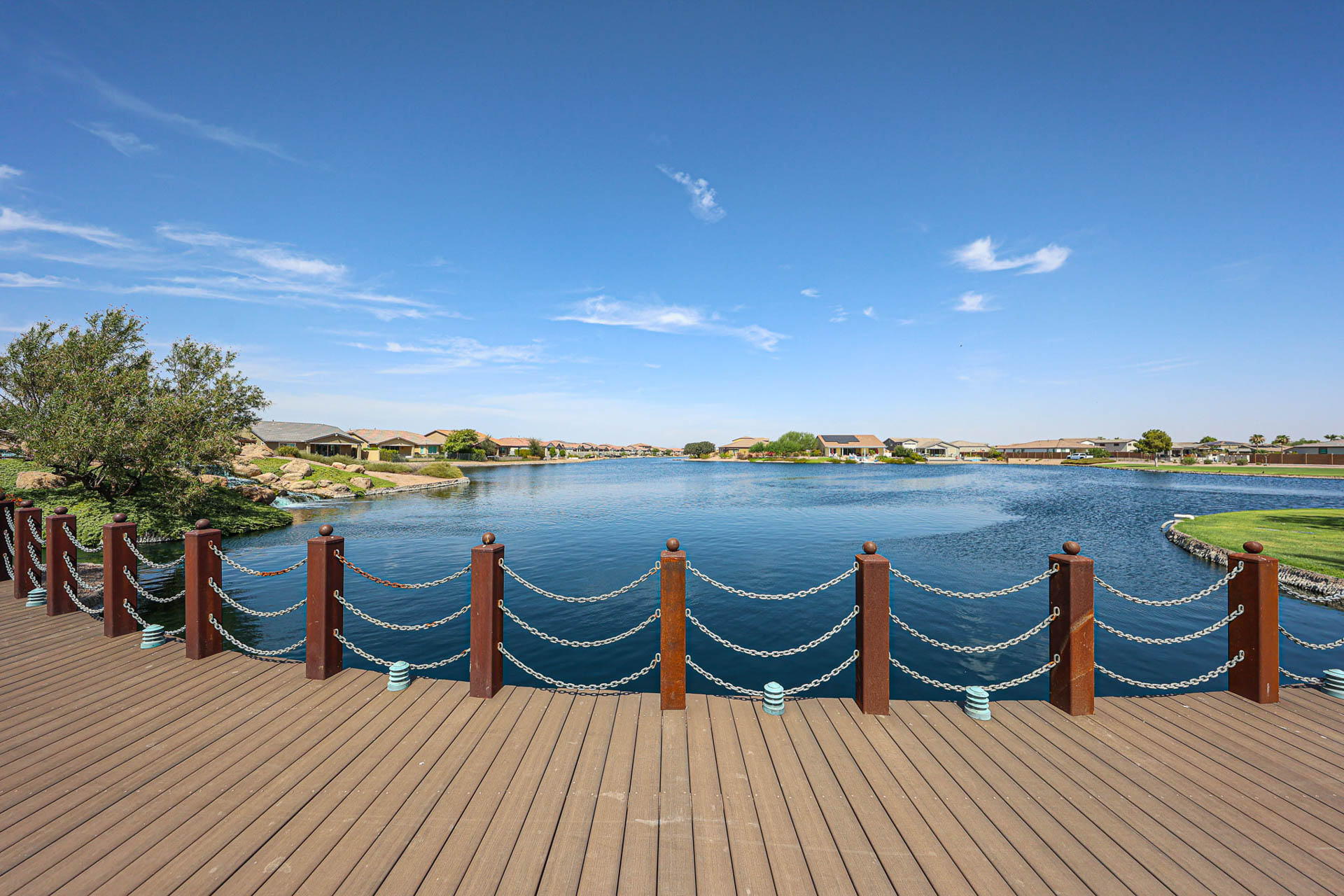 A wood deck overlooking a body of water.