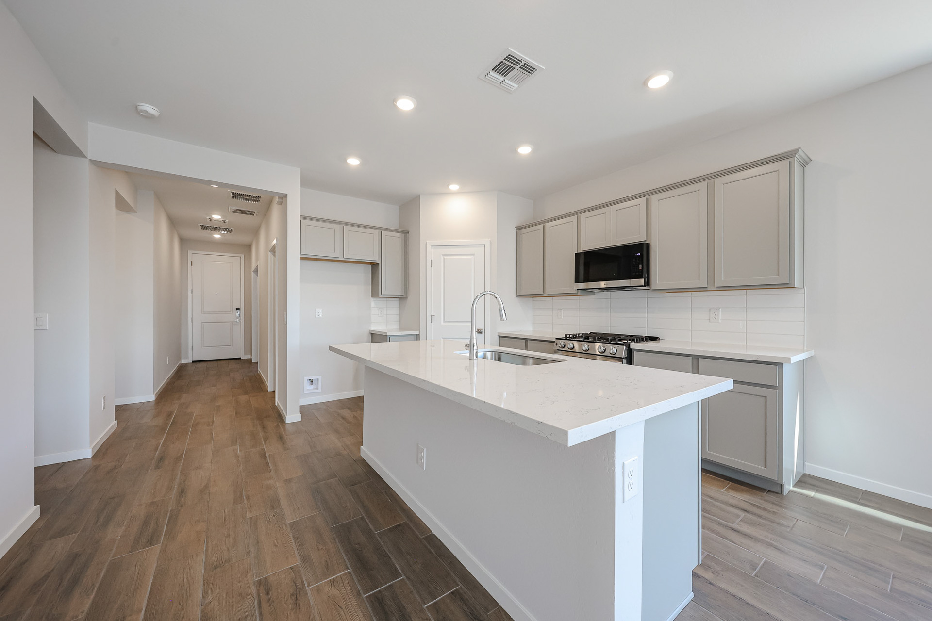 A kitchen with white cabinets.